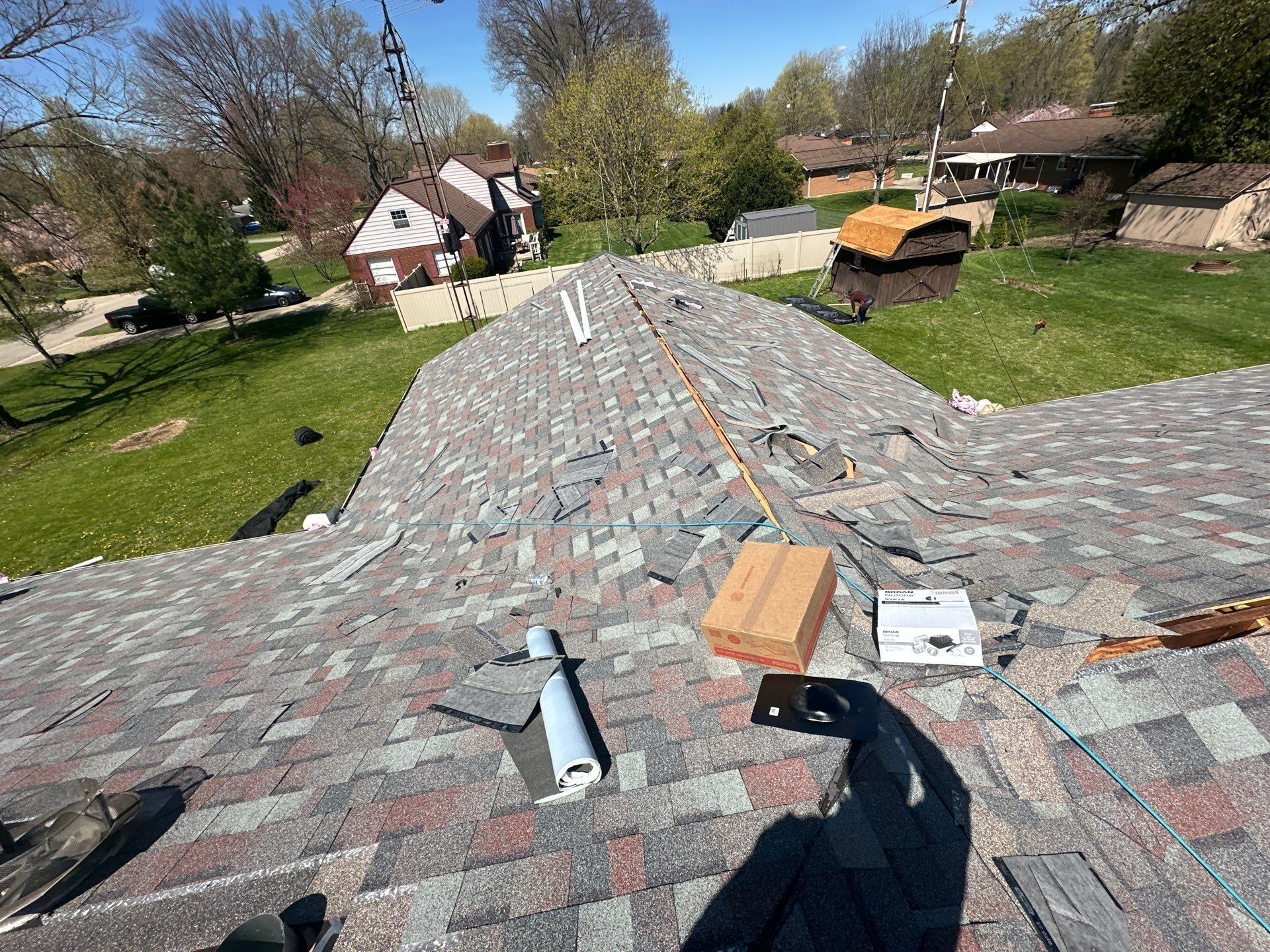 Hip and valley shingles going on around a new vent opening, Beavercreek, Ohio.