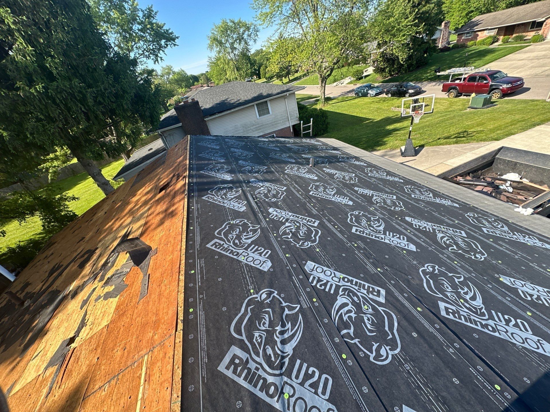 Synthetic underlayment on the front slope as tear-off continues on the next, Beavercreek, Ohio.