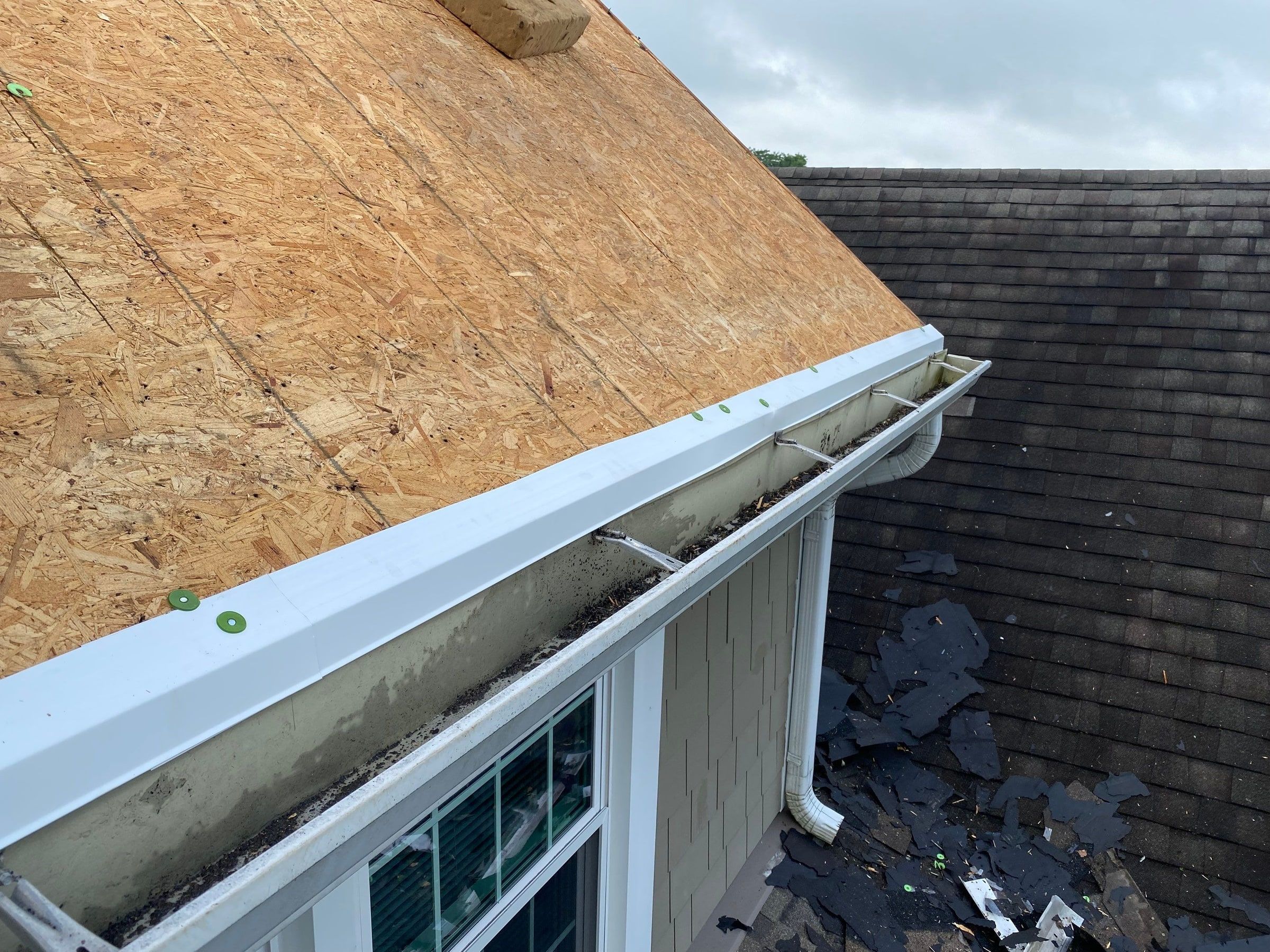New white drip edge fastened along the eave above the gutter, Yellow Springs, Ohio.