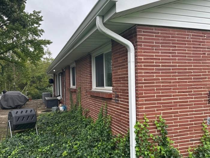 A new gutter and downspout at a brick corner above the ivy, West Carrollton, Ohio.