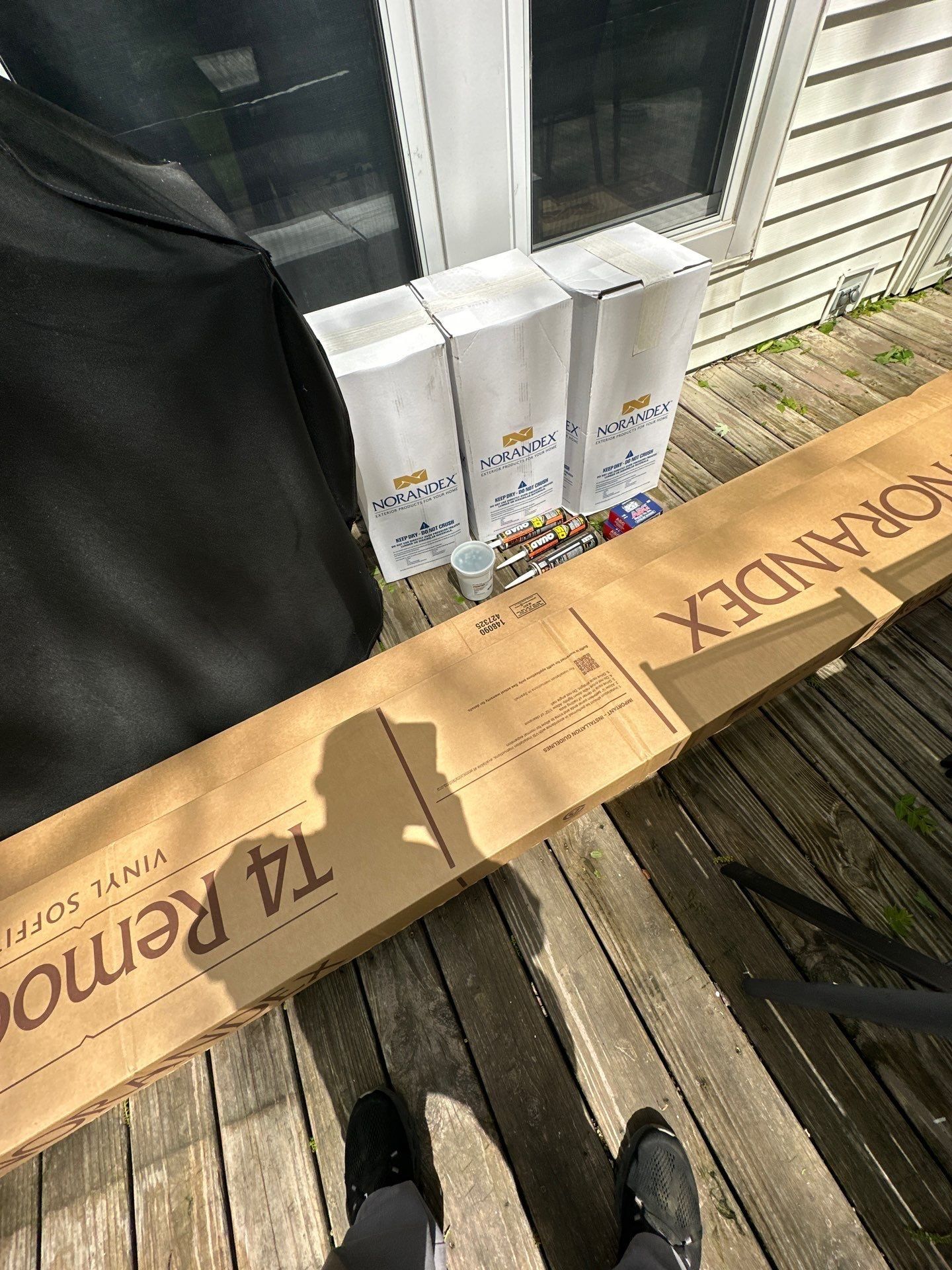 Norandex soffit cartons and sealant on the deck