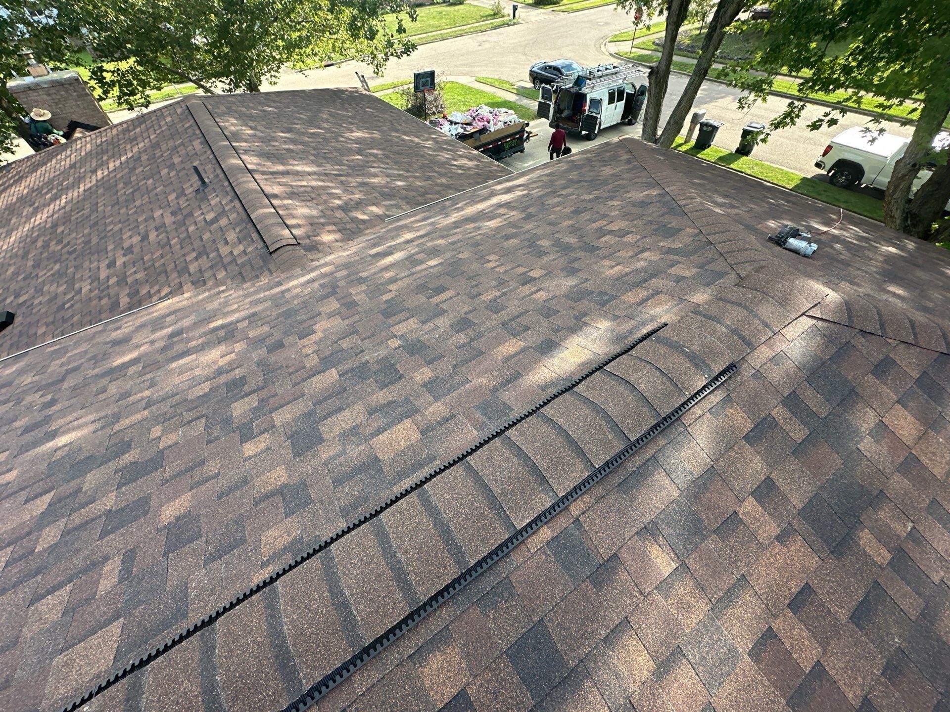 The finished roof with ridge vent and roof vents, looking toward the street, Dayton, Ohio.