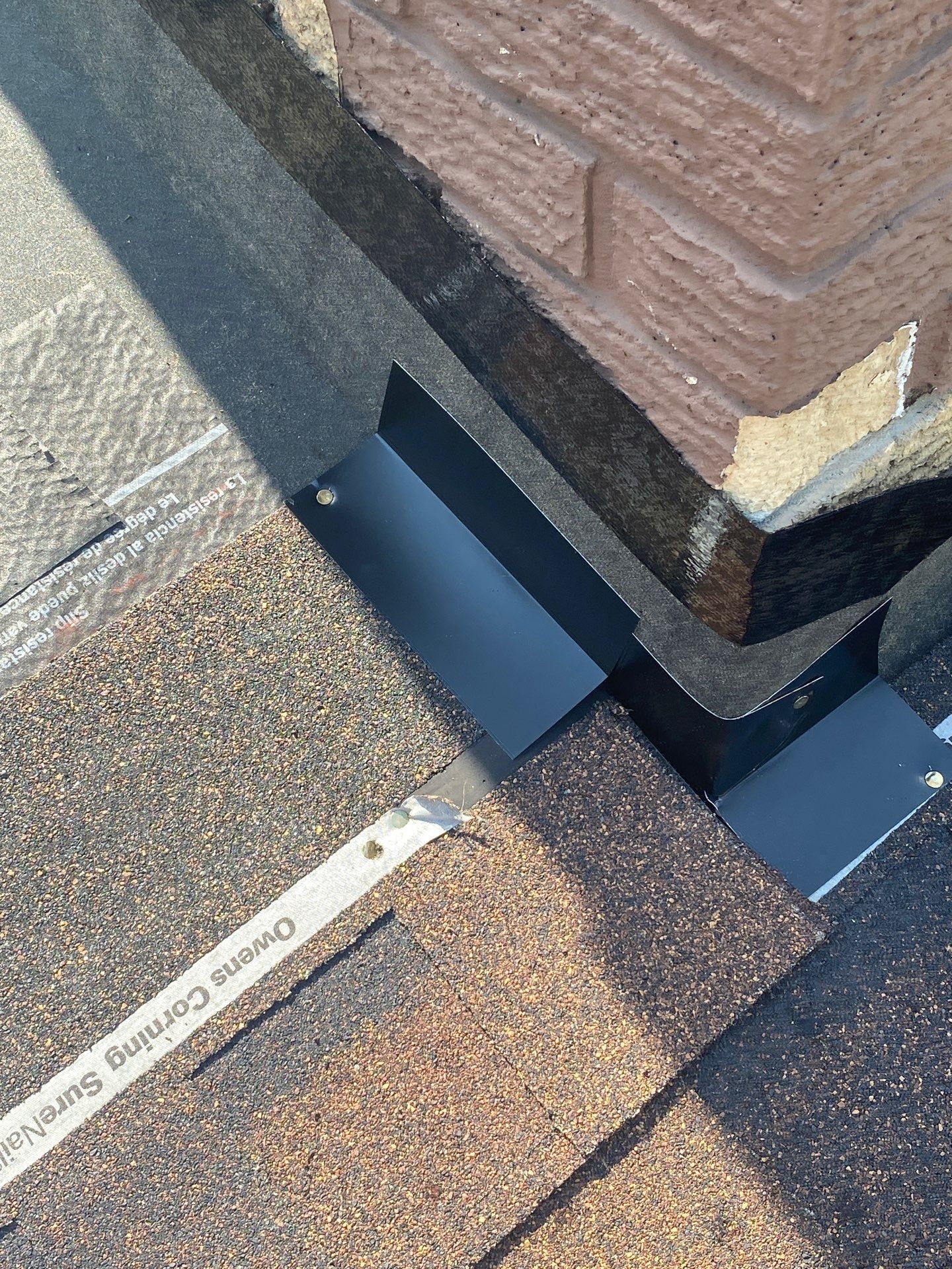 New step flashing set at the corner of the brick chimney, Beavercreek, Ohio.
