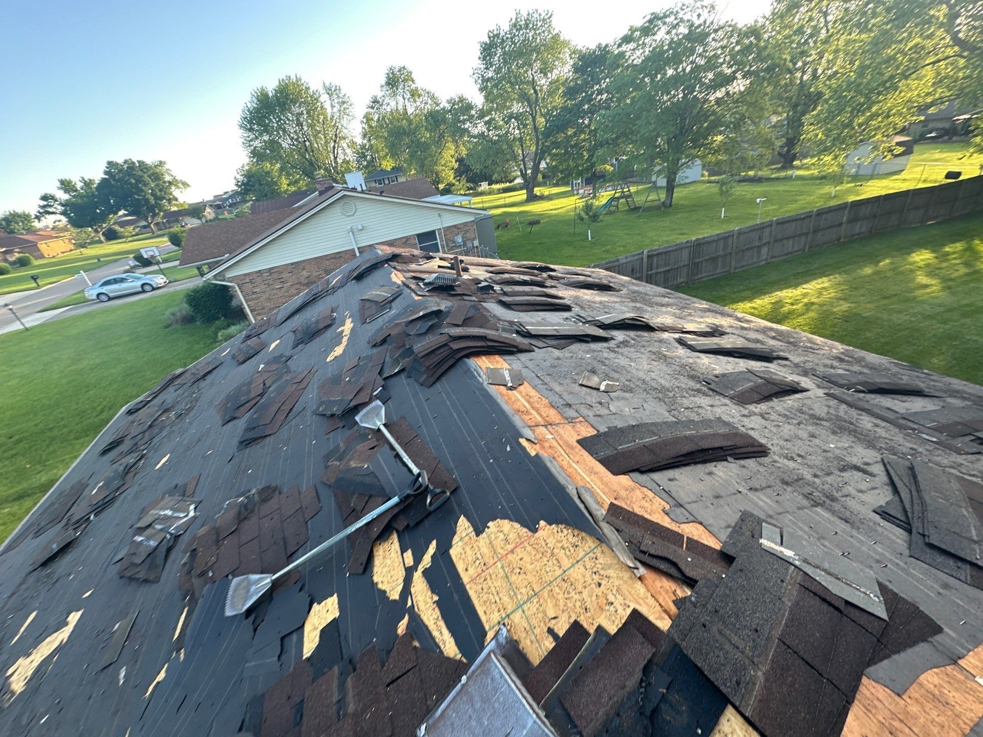 A shingle shovel and torn-off shingles on the back slope, Beavercreek, Ohio.