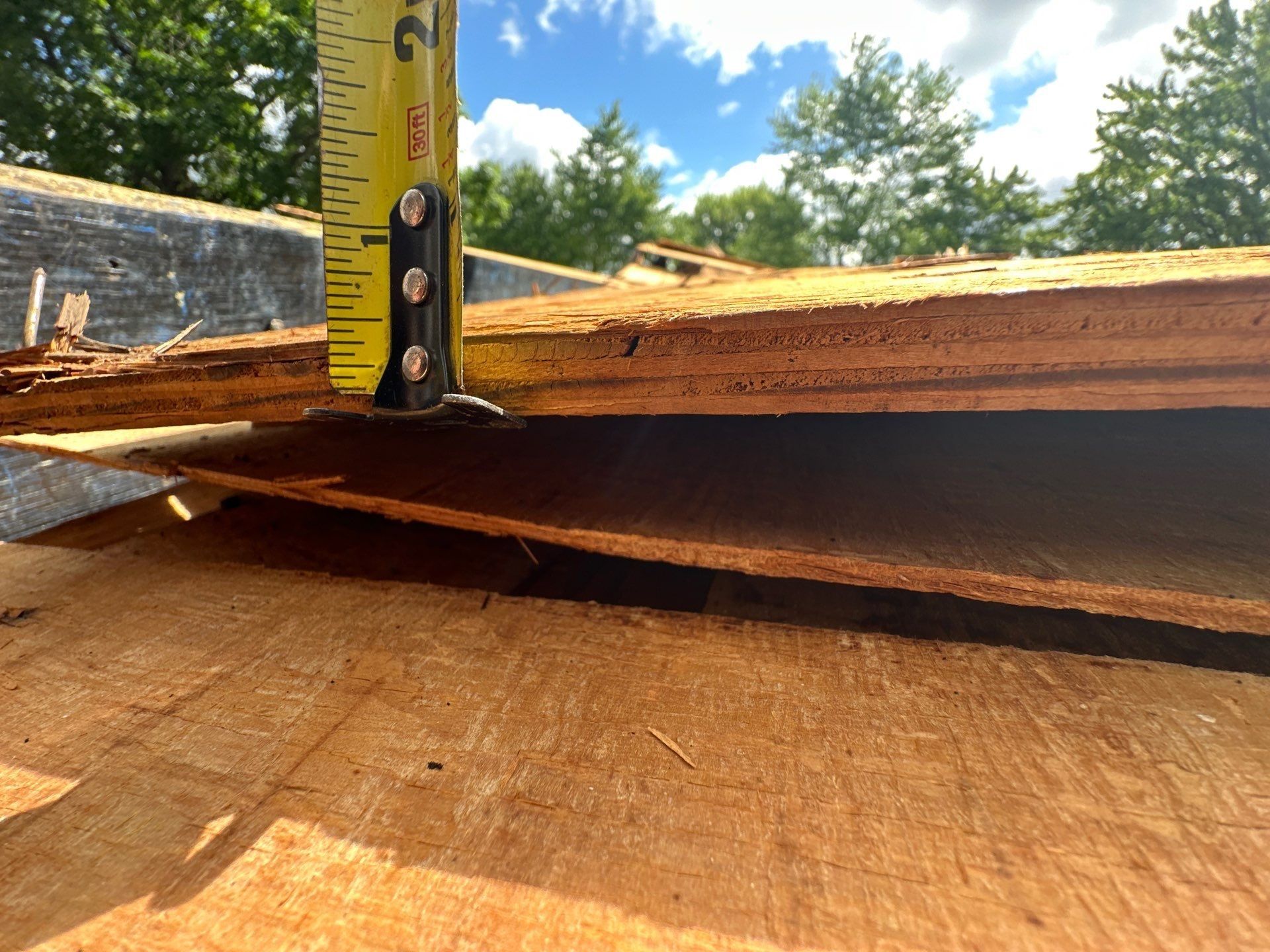 Measuring the thickness of the old plywood sheathing, Dayton, Ohio.