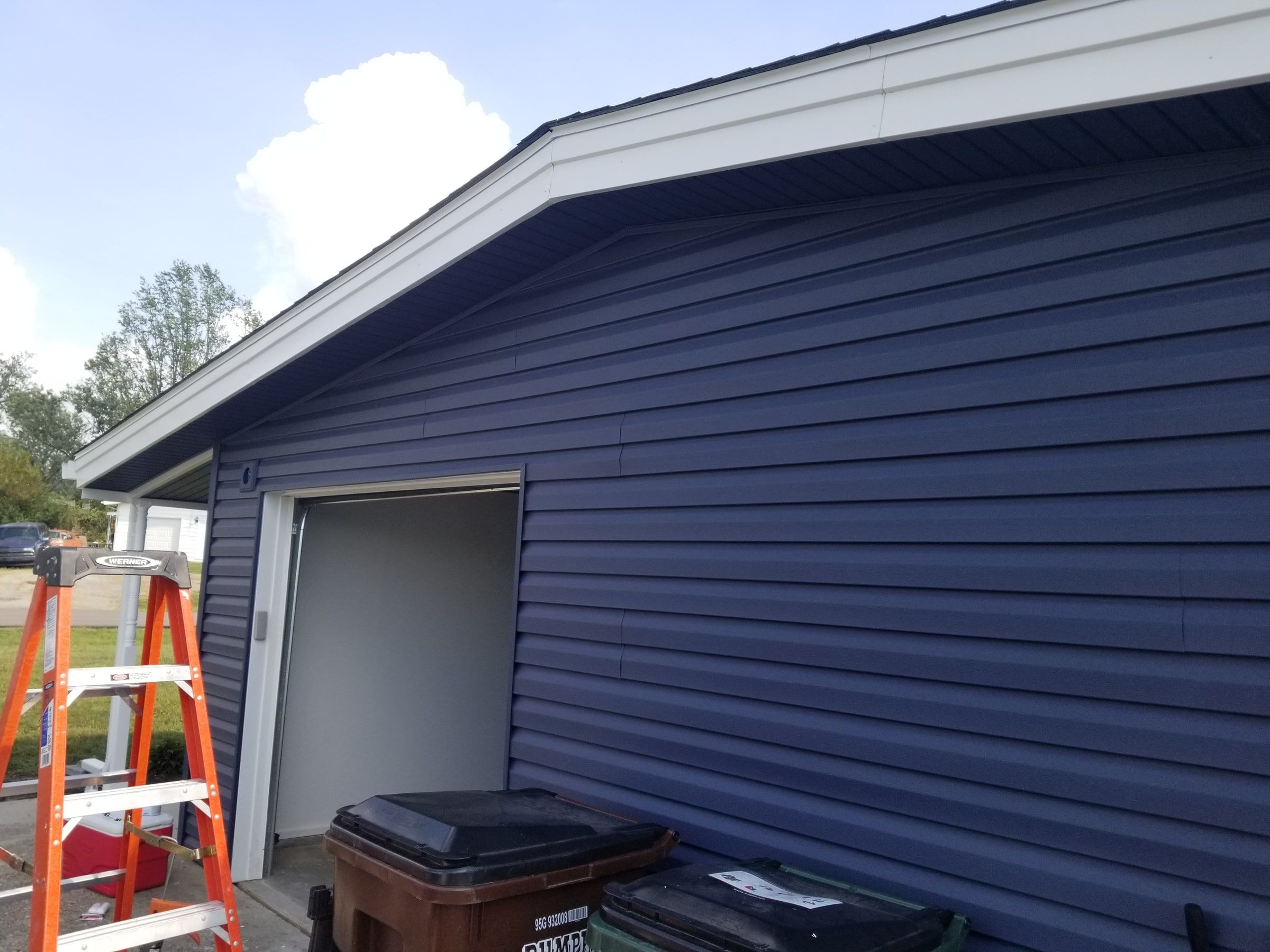 The gable over the garage door in new blue siding, Beavercreek, Ohio.