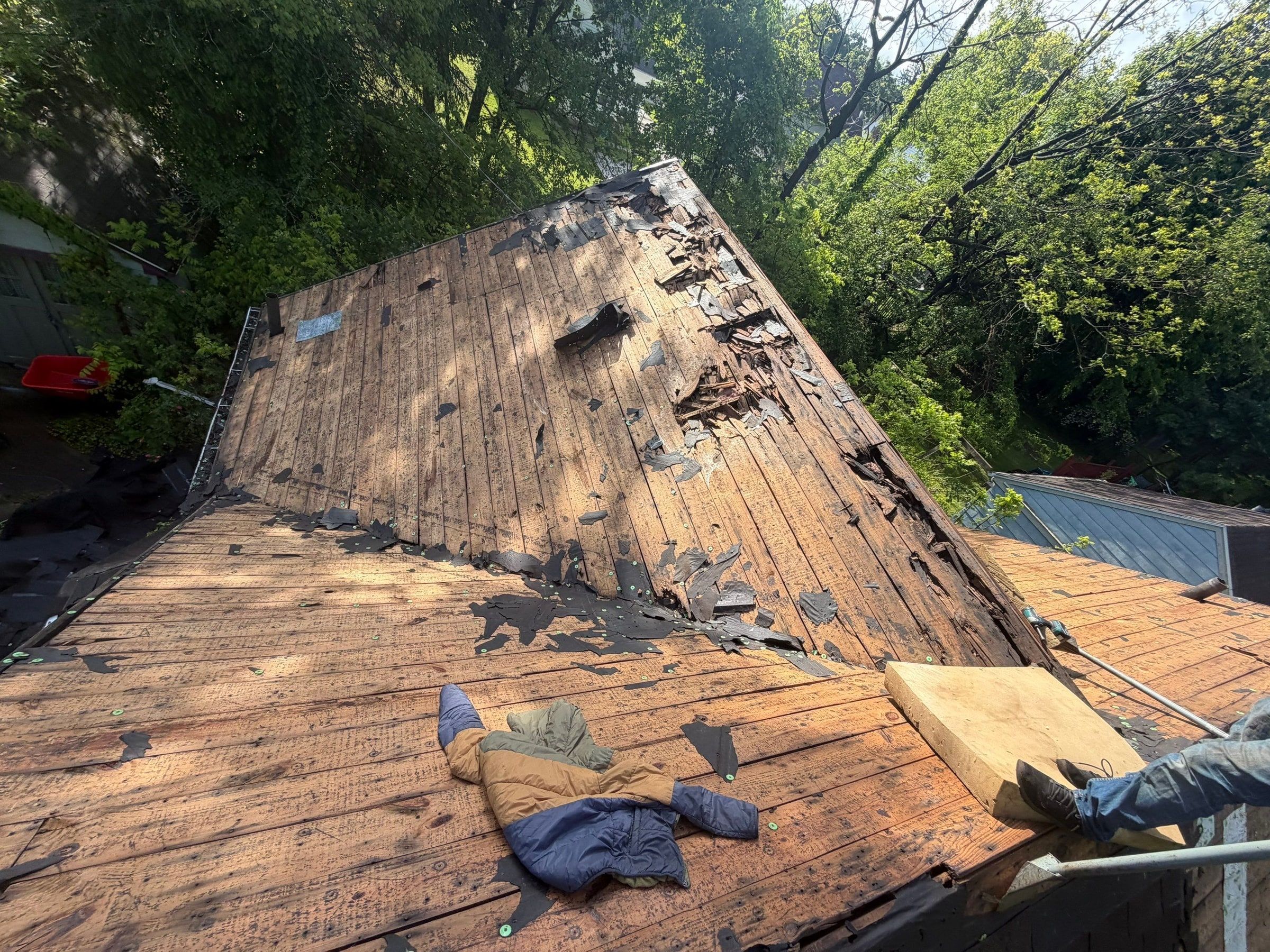 Two stripped slopes of plank decking with rot along the top, Springfield, Ohio.