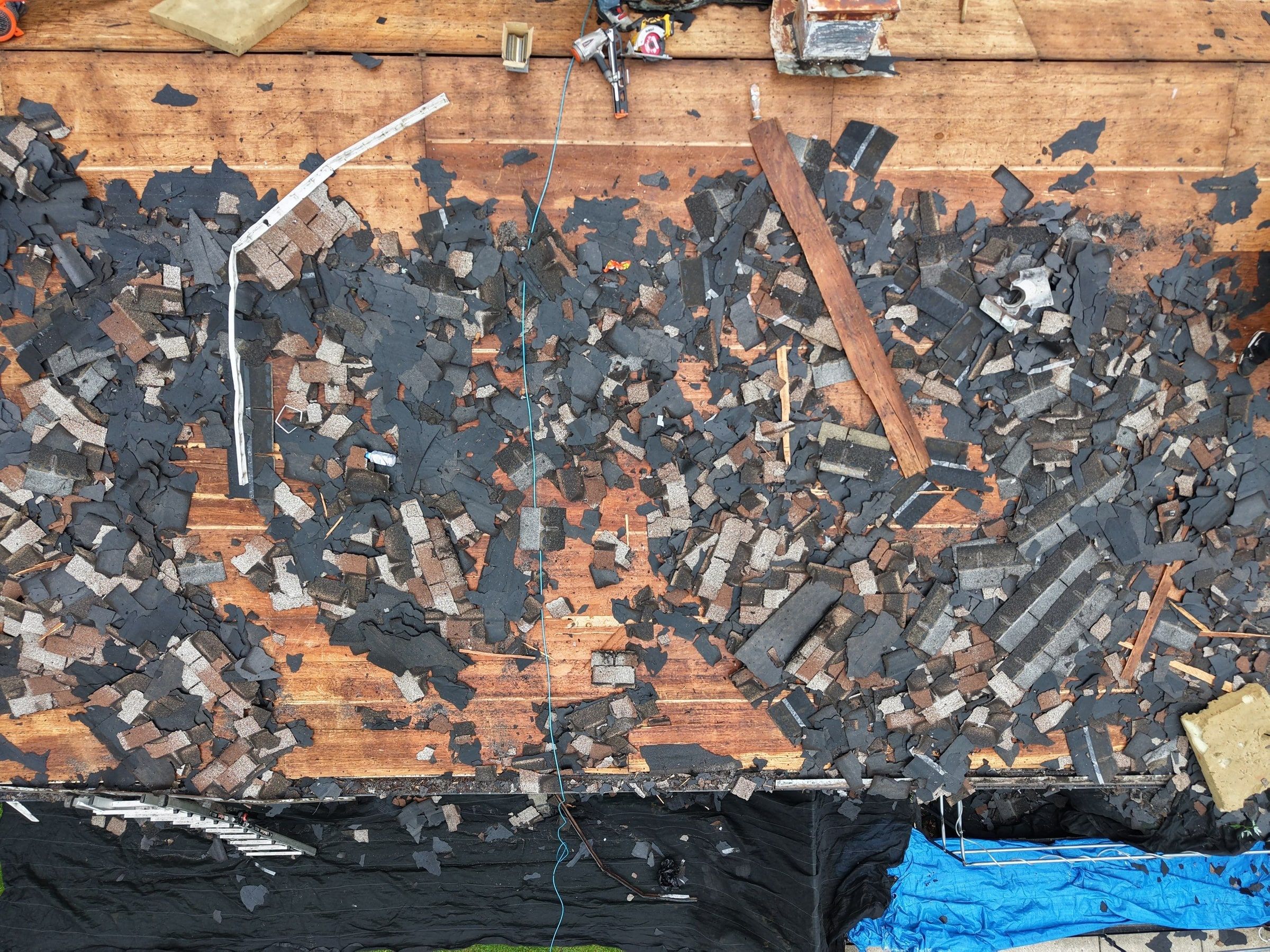 Straight down from the drone on the torn-up roof, with tarps along the front of the house, Dayton, Ohio.