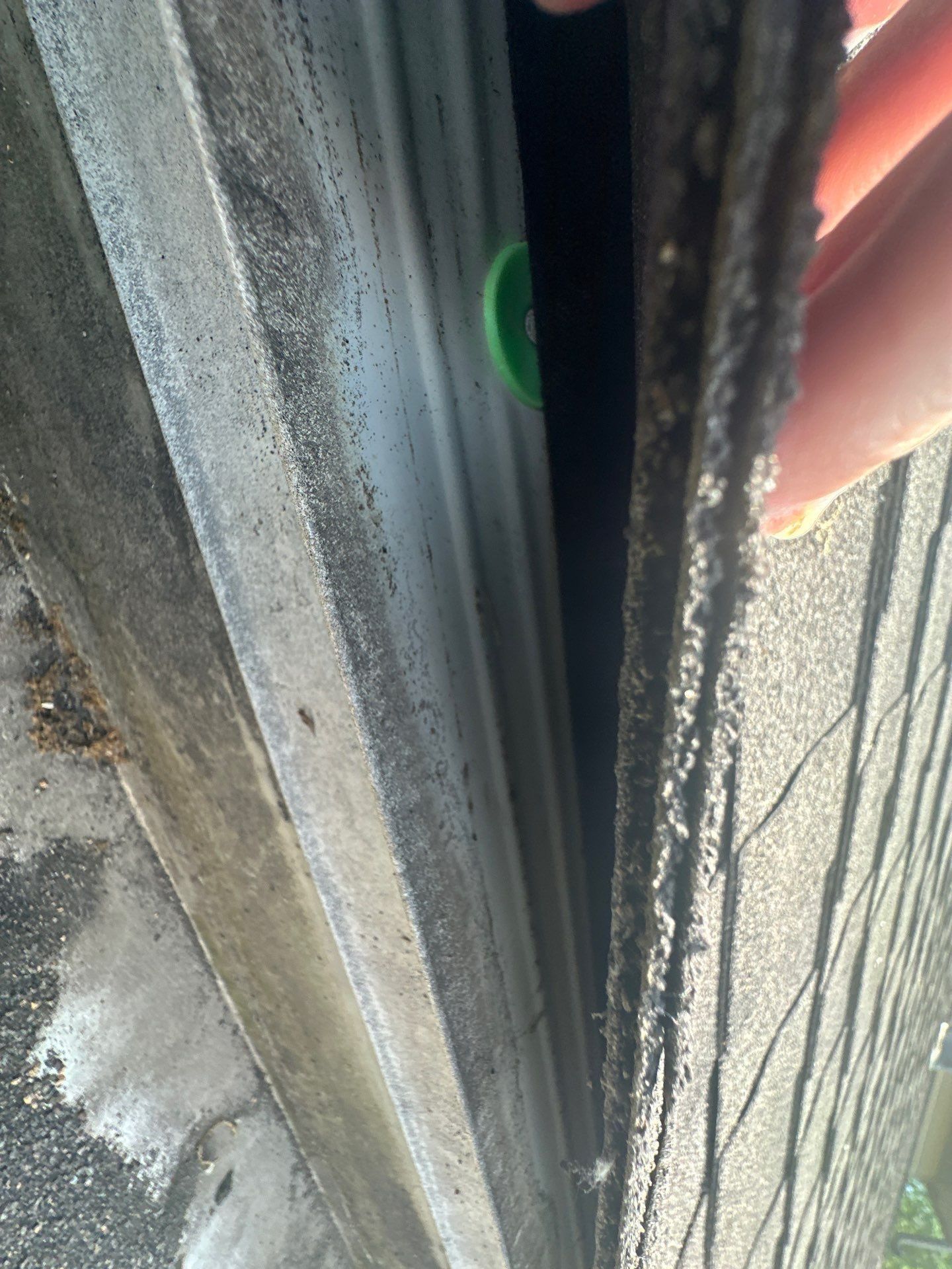 Inside the gutter along the eave