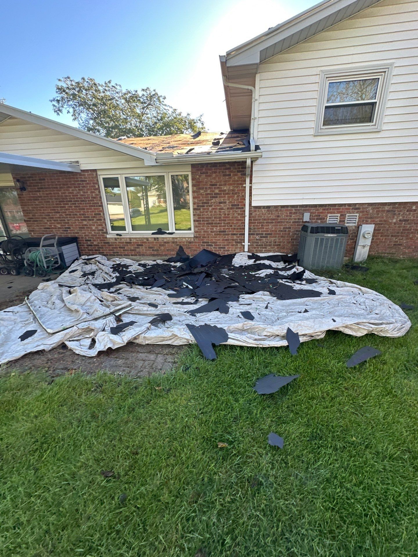 Tarps under the back wall catching torn-off shingles, West Carrollton, Ohio.