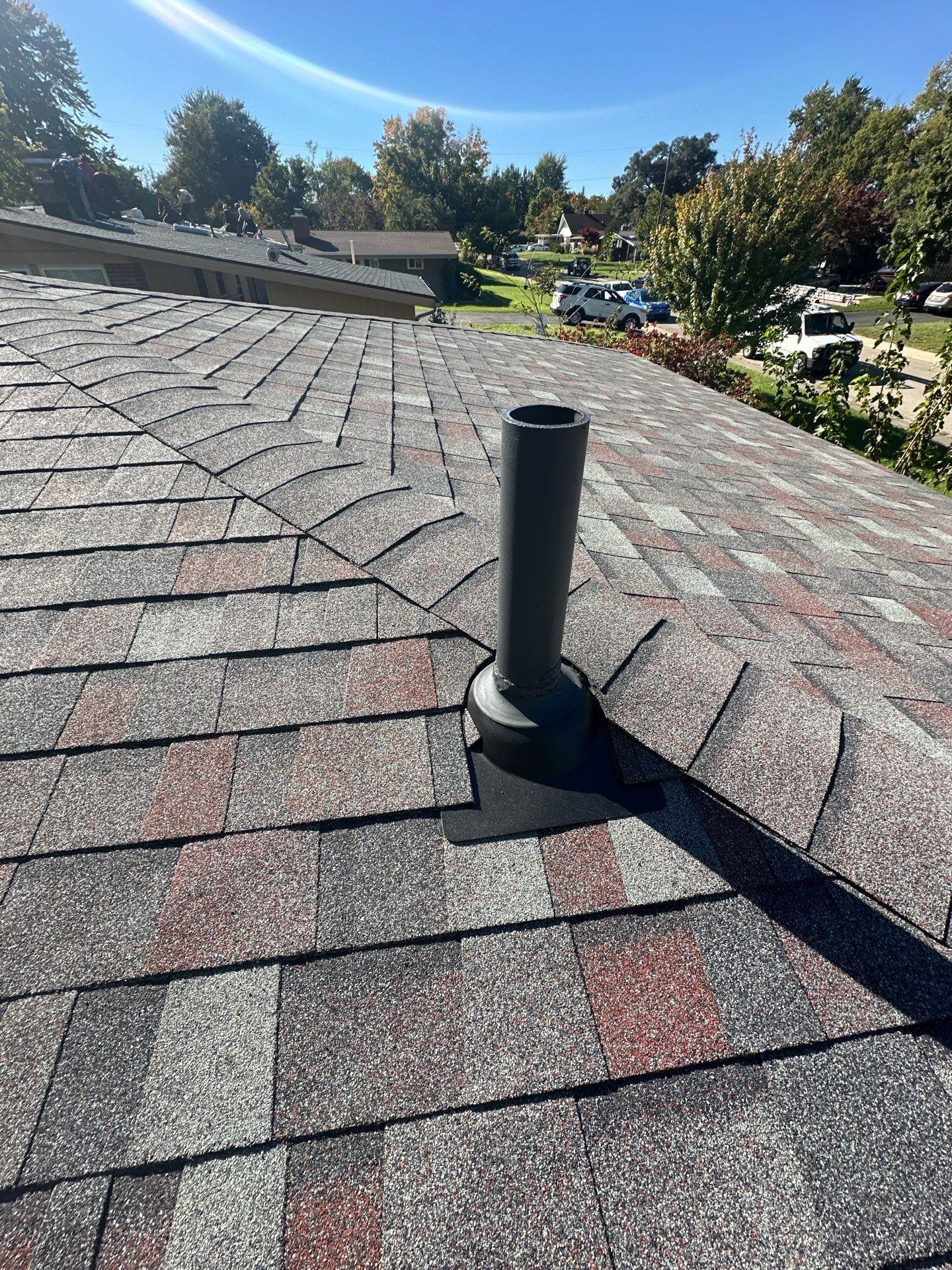A new pipe vent on the finished slope, with ridge caps above, Kettering, Ohio.