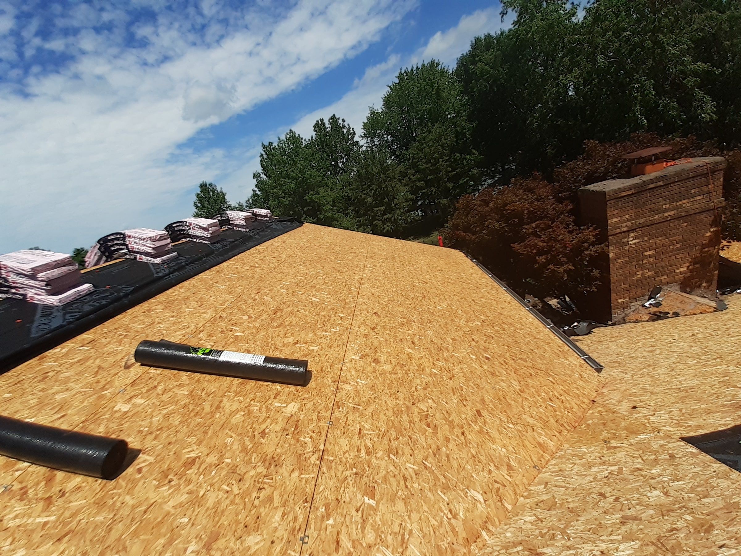 Original deck near the chimney with drip edge rolls laid out, Jamestown, Ohio.