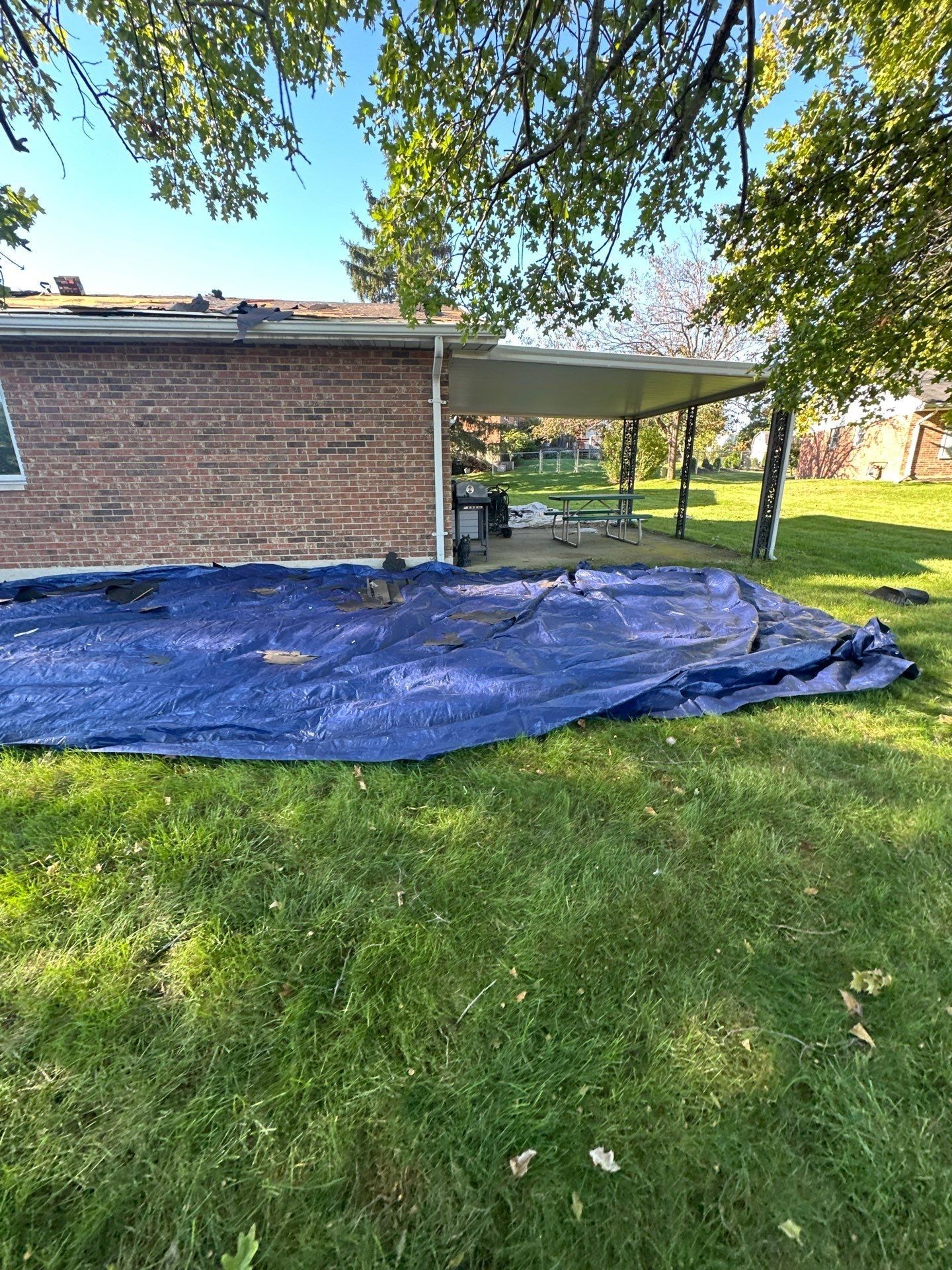 A tarp spread on the lawn beside the covered patio, West Carrollton, Ohio.