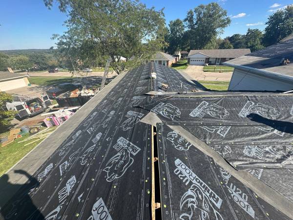 Underlayment over the hips and valley of the lower roof, West Carrollton, Ohio.