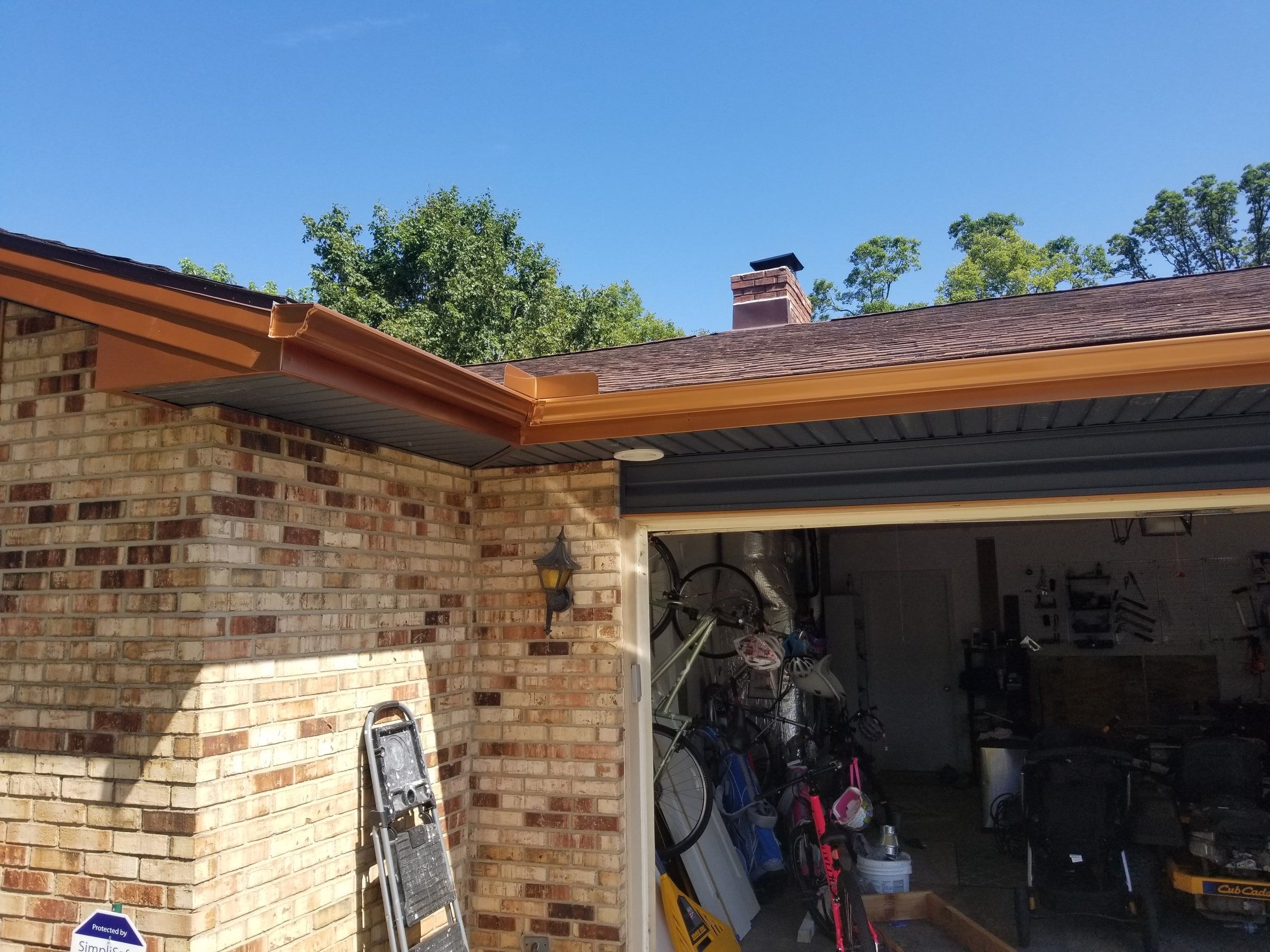 New gray soffit and copper-colored trim at the garage corner, Beavercreek, Ohio.