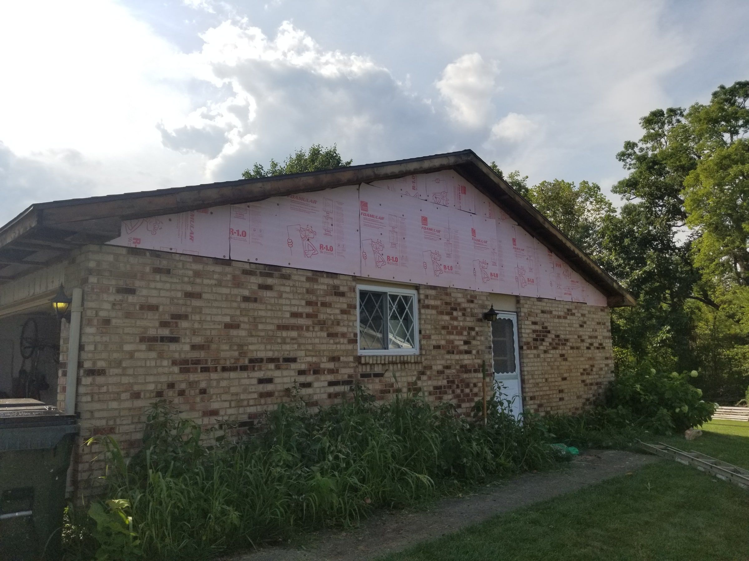 Fanfold insulation board on the gable above the brick wing, Beavercreek, Ohio.