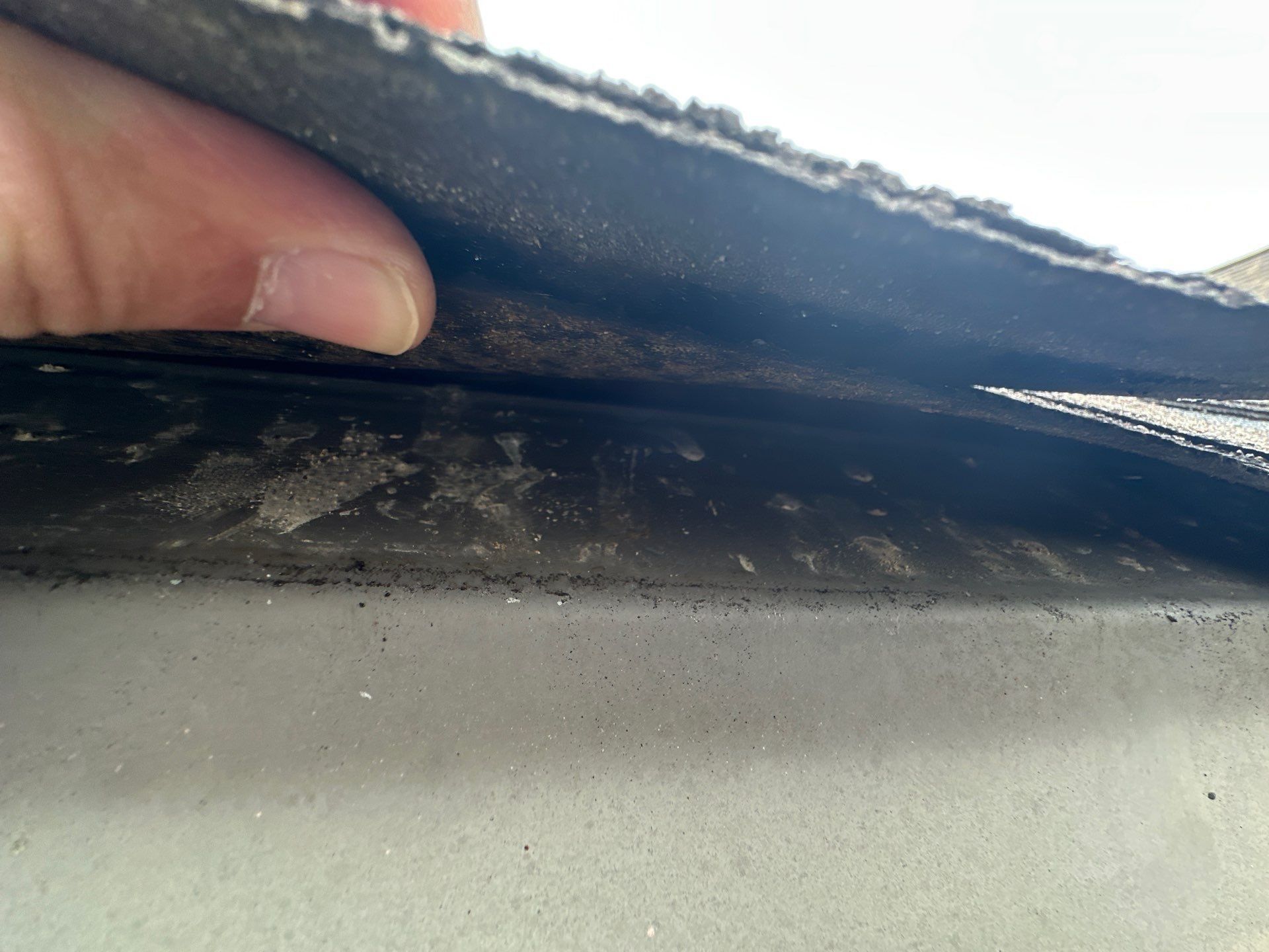 Shingle edge held clear of the gutter