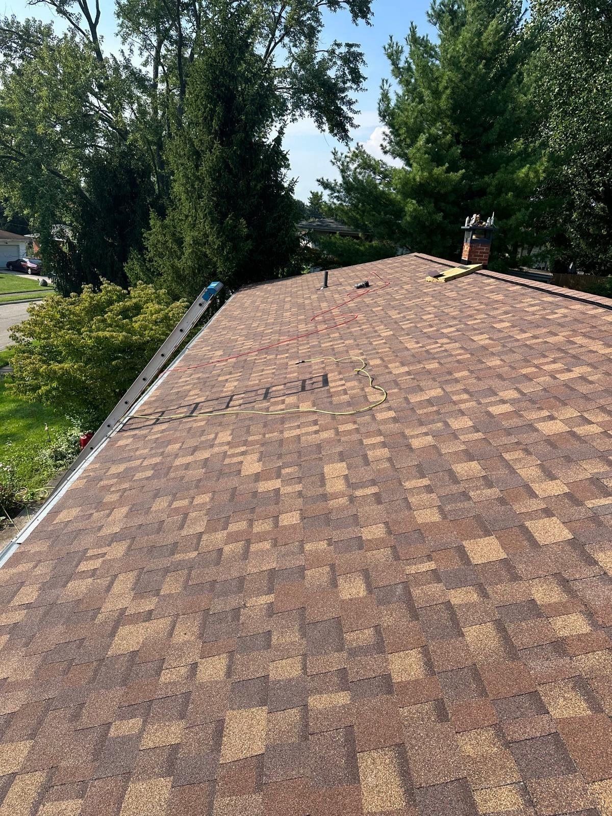 The finished roof with the ladder at the eave and the chimney beyond, Fairborn, Ohio.
