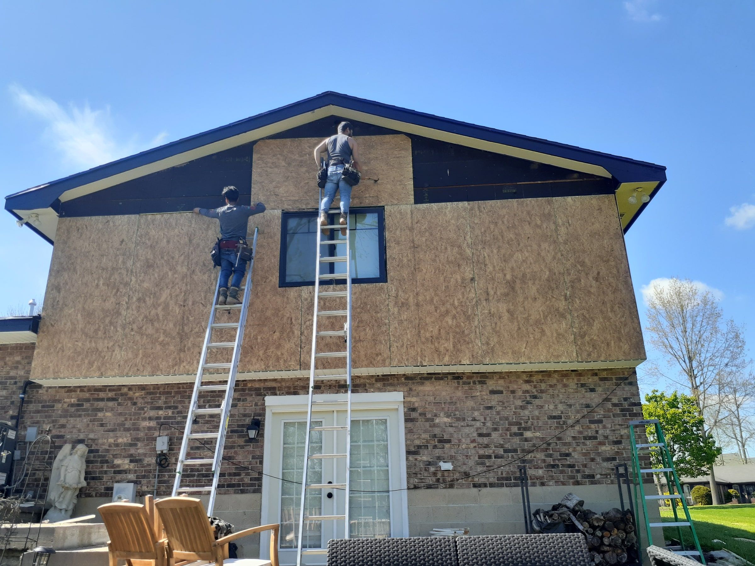 The crew on ladders putting up OSB on the back gable, Beavercreek, Ohio.
