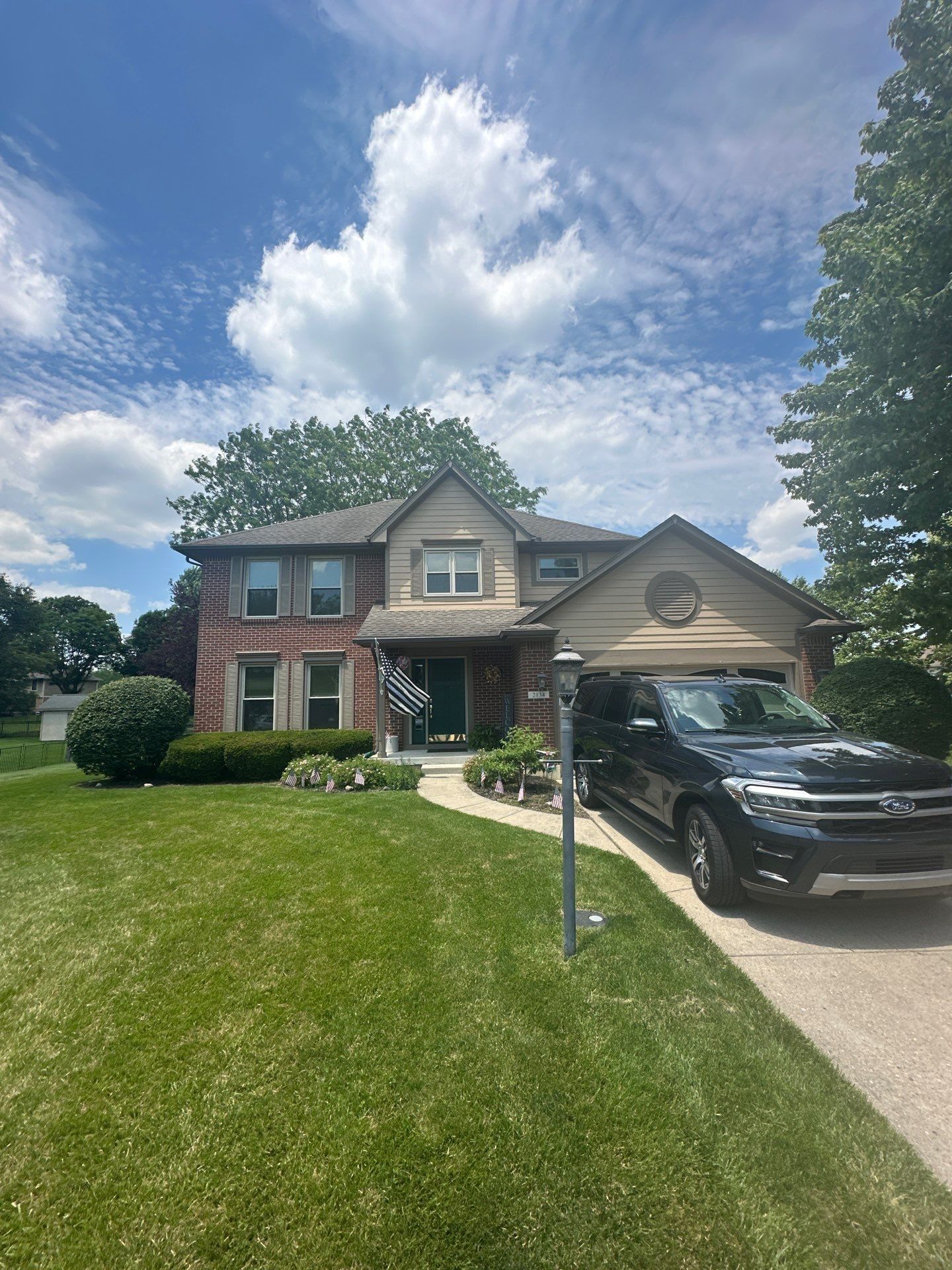 Brick and siding house from the driveway