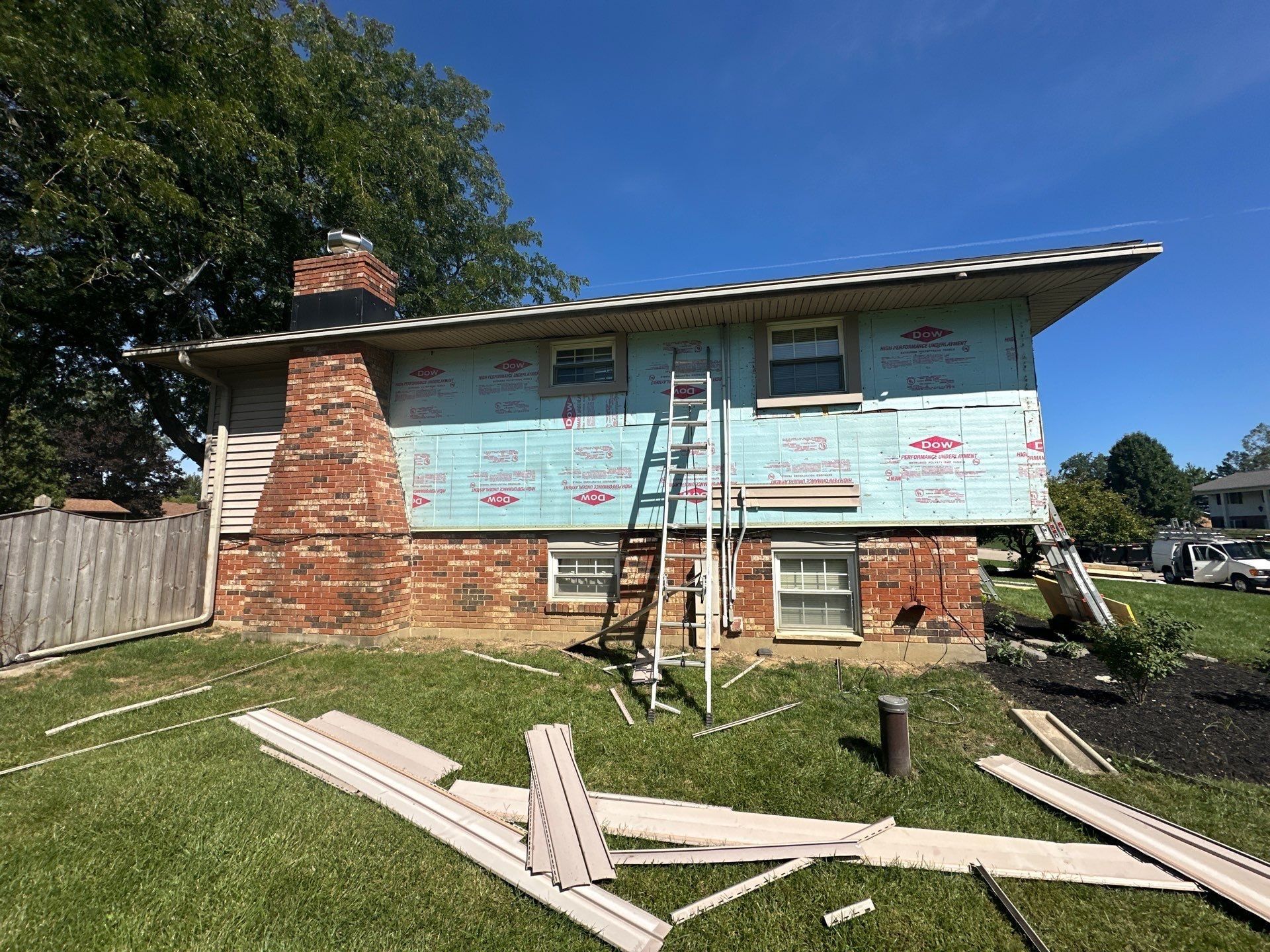 House wrap on the upper back wall beside the brick chimney, Beavercreek, Ohio.