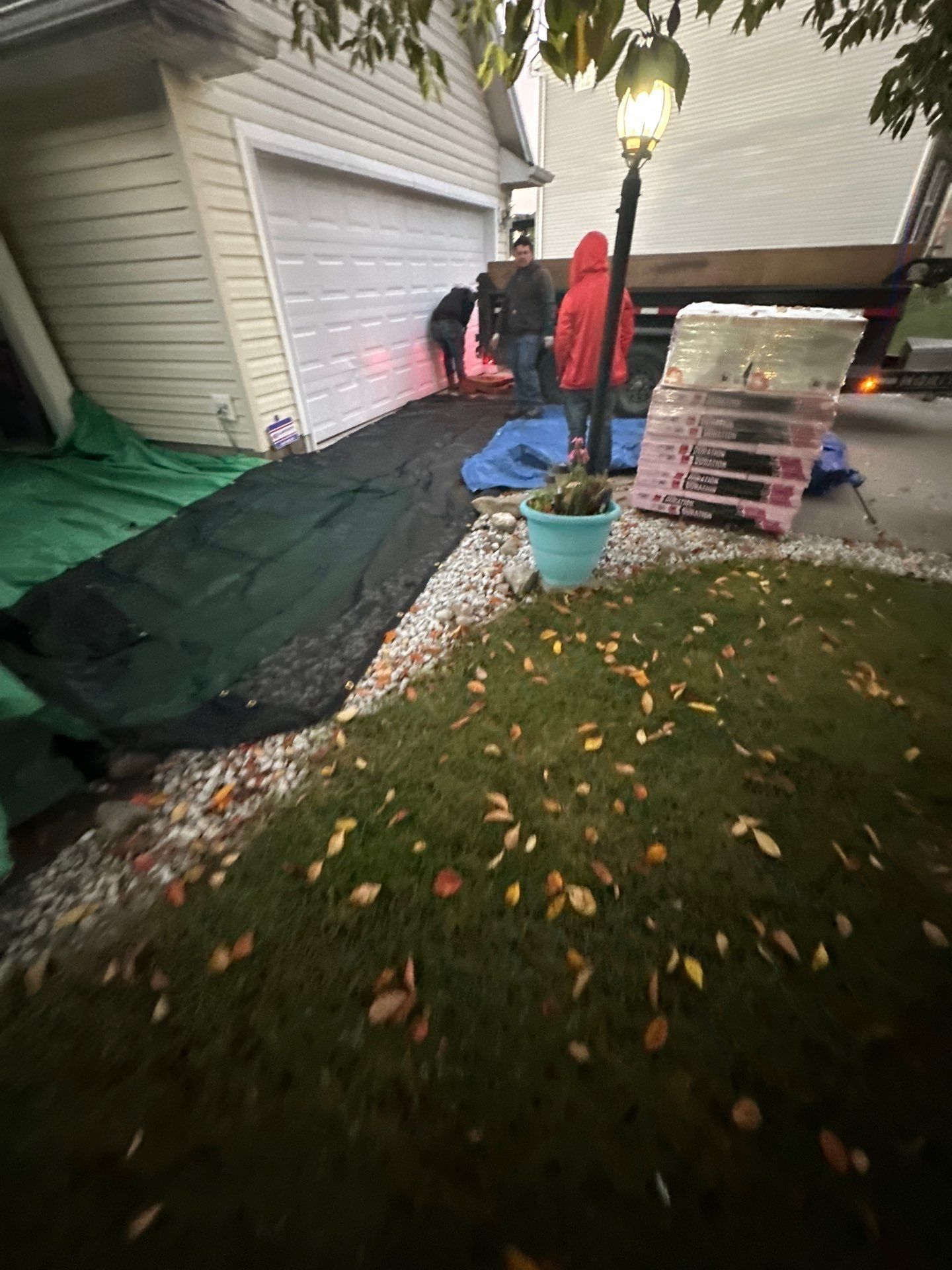 Tarps over the front landscaping, with the crew and materials on the driveway, Beavercreek, Ohio.