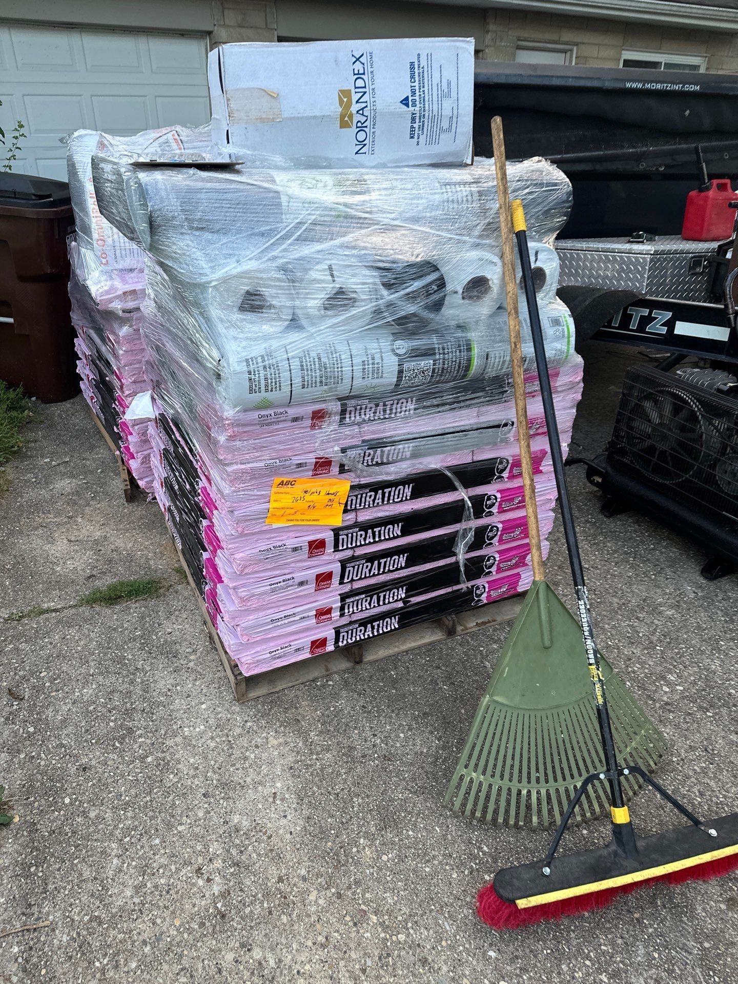 A pallet of Owens Corning Duration shingles and underlayment rolls by the garage, Fairborn, Ohio.