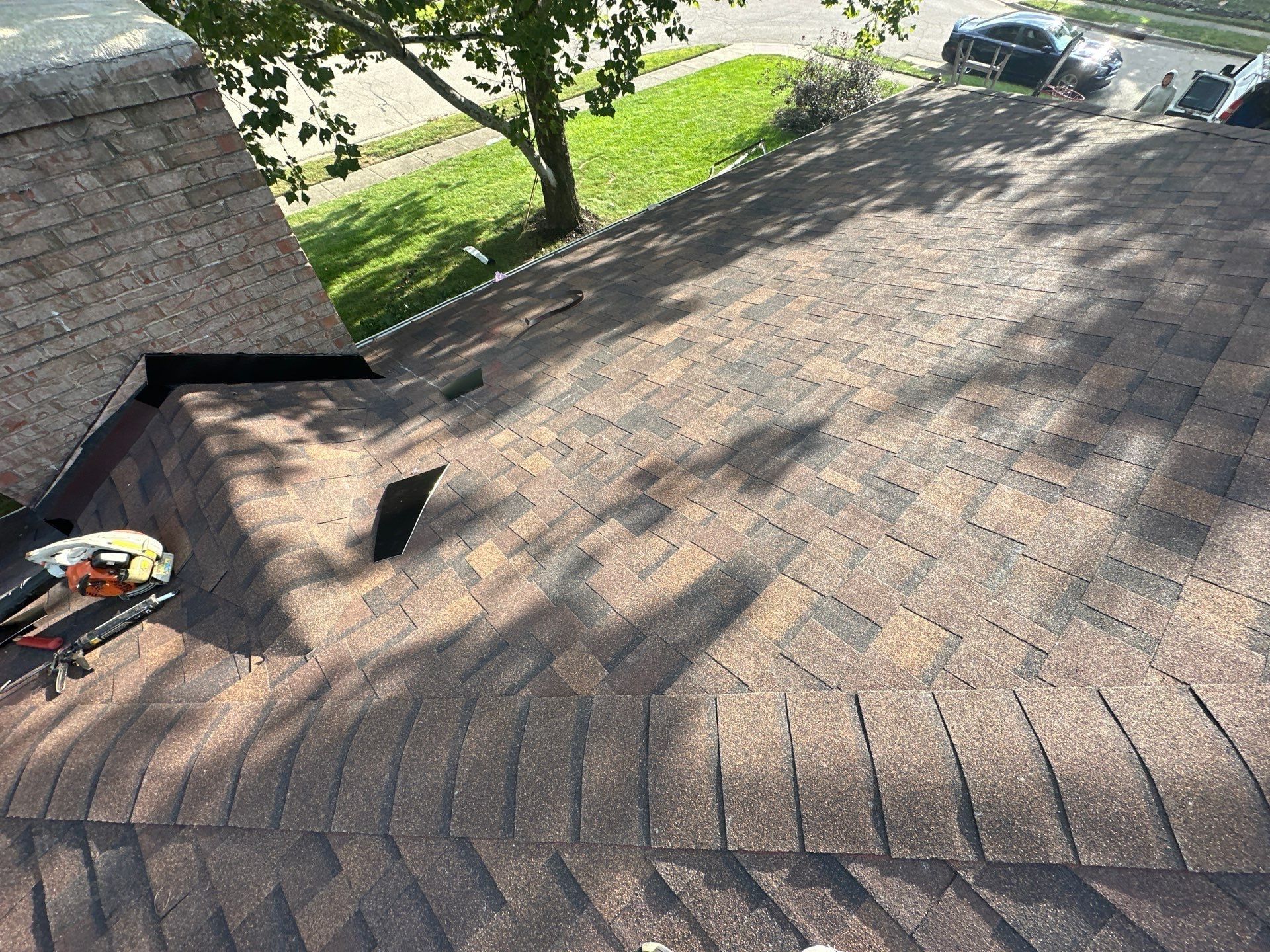 The finished slope by the brick chimney, with roof vents near the ridge, Dayton, Ohio.