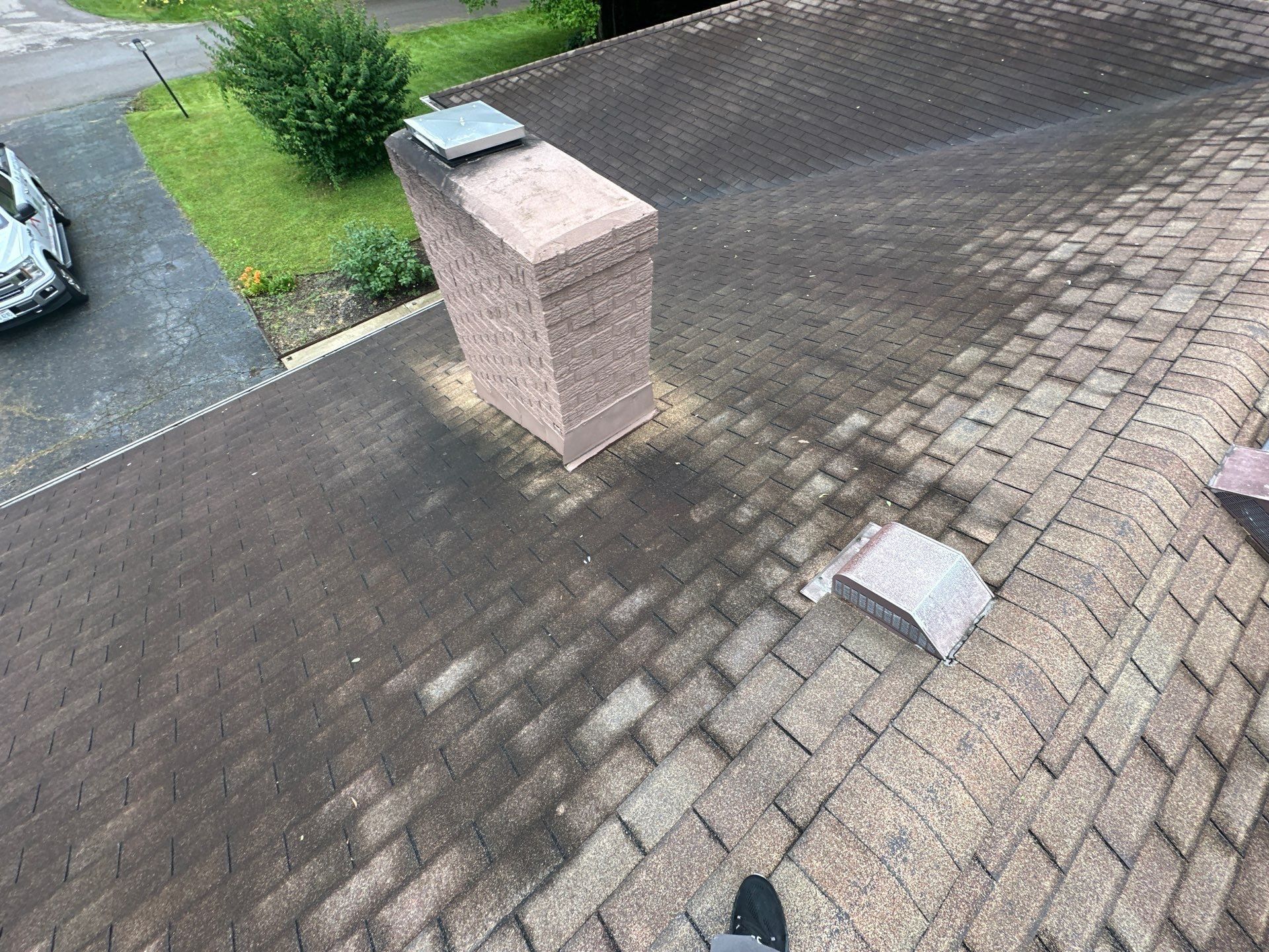Brick chimney and box vent on the worn shingle roof, Beavercreek, Ohio.