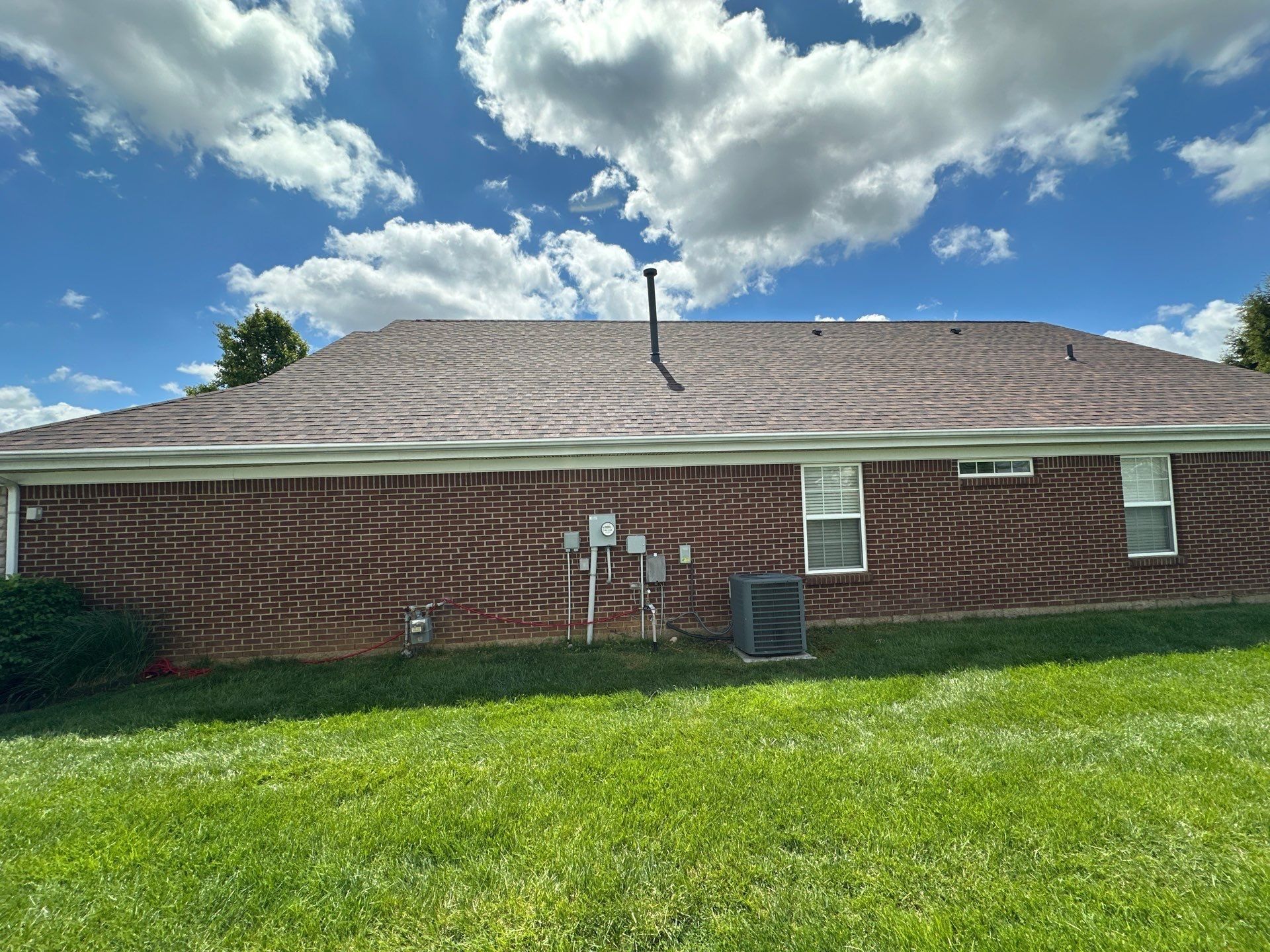 Roof above the brick wall and condenser