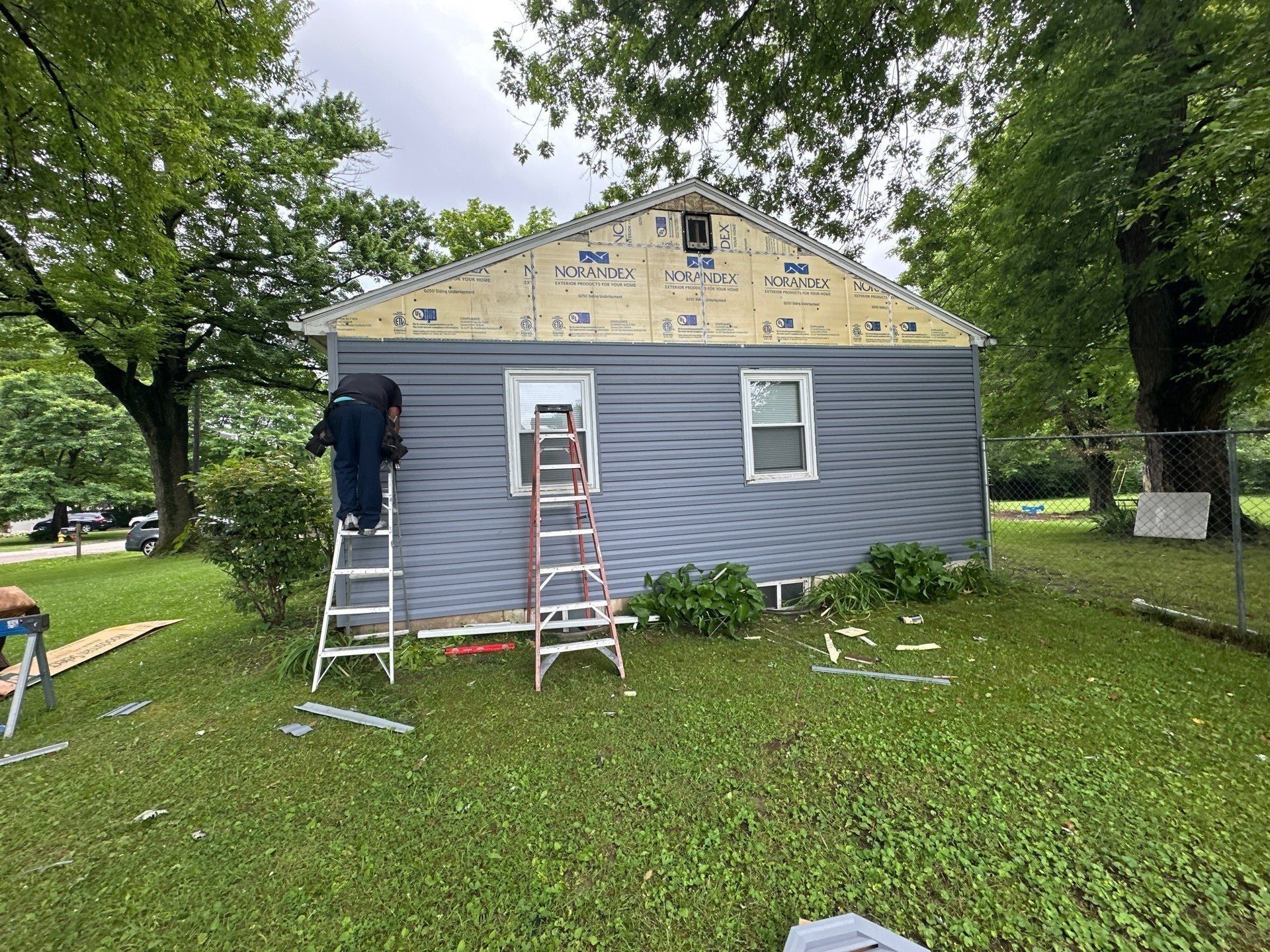 Siding going on at the back gable with ladders against the wall, Beavercreek, Ohio.