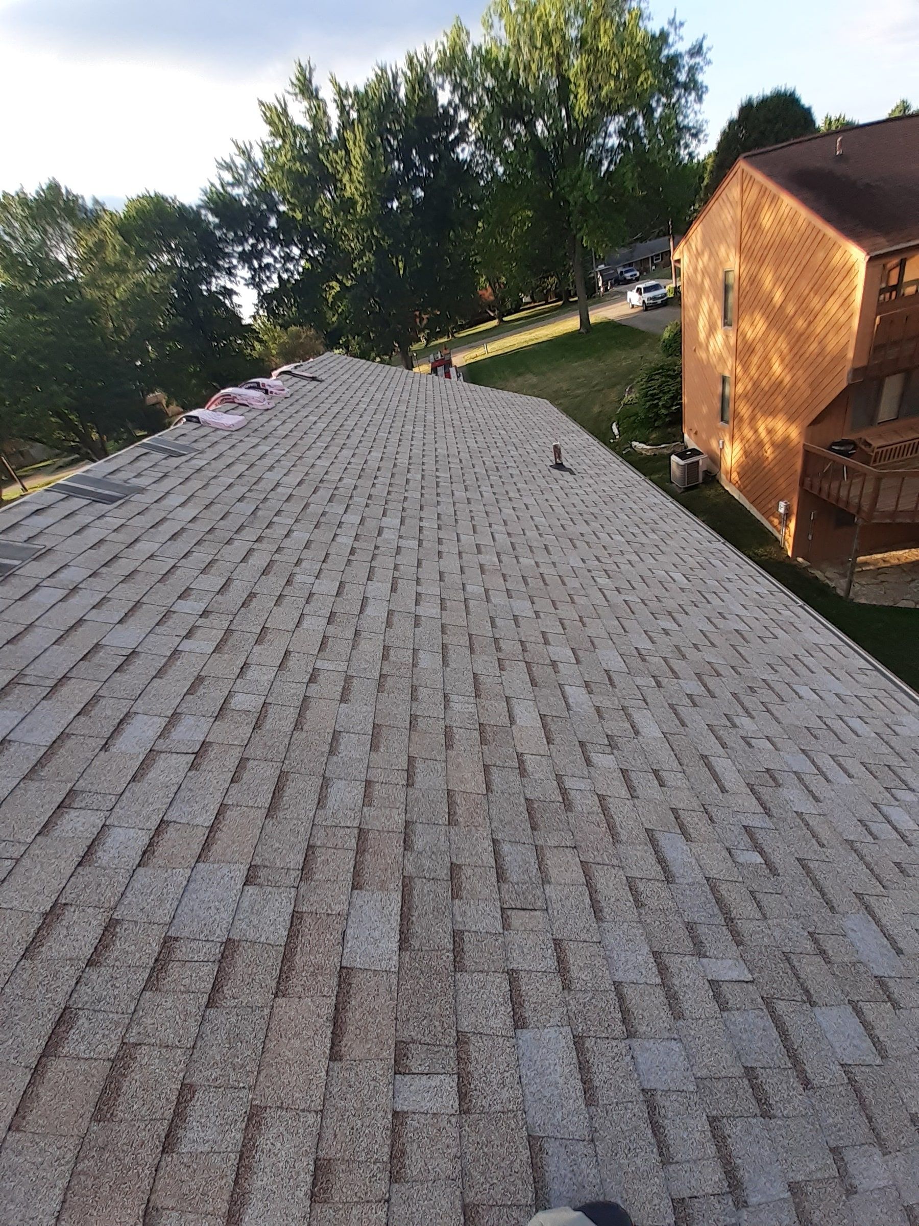 Long side slope of new shingles running toward the street, Jamestown, Ohio.