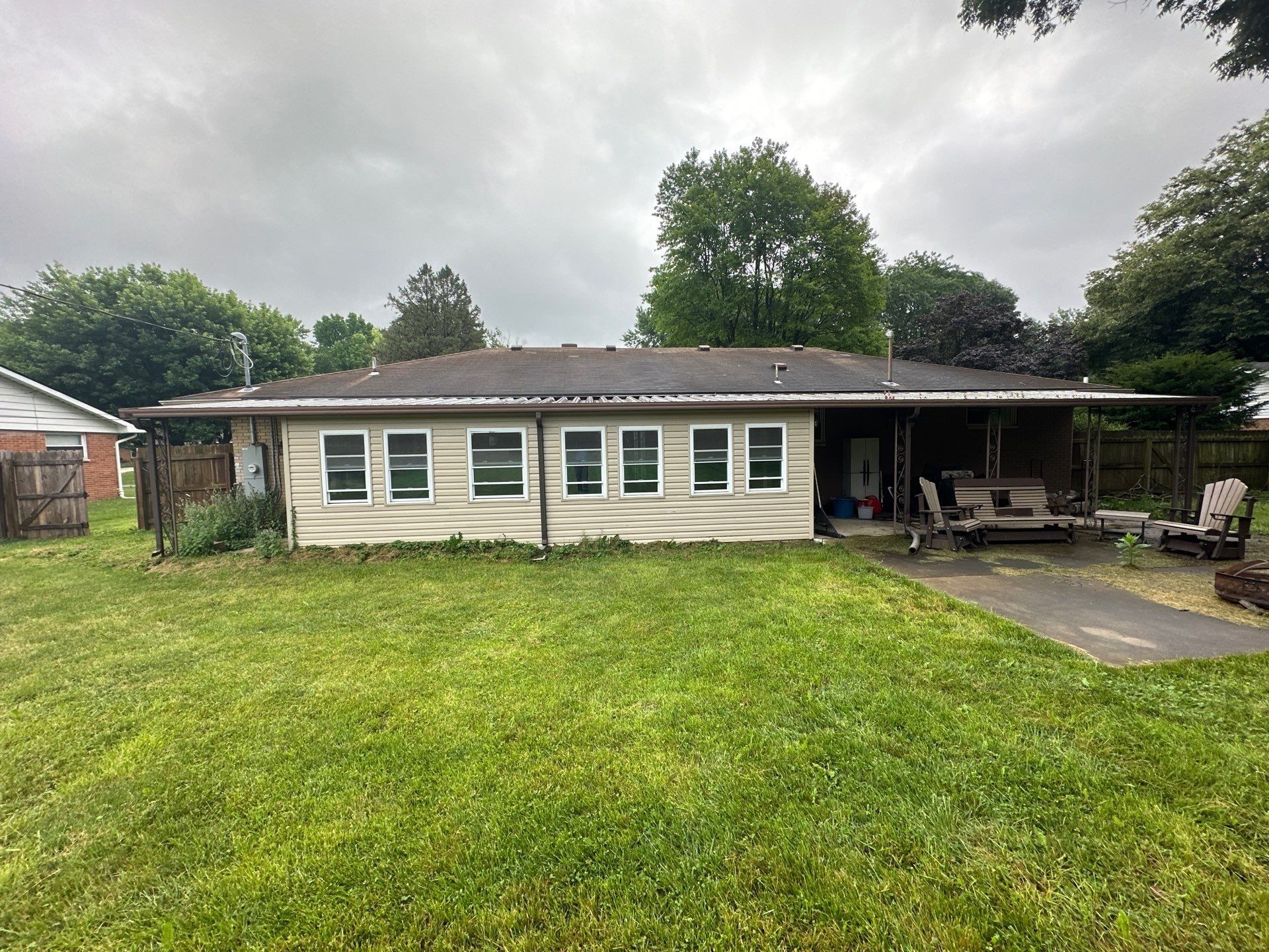 Back of the house with a sunroom addition and patio before work began, Beavercreek, Ohio.