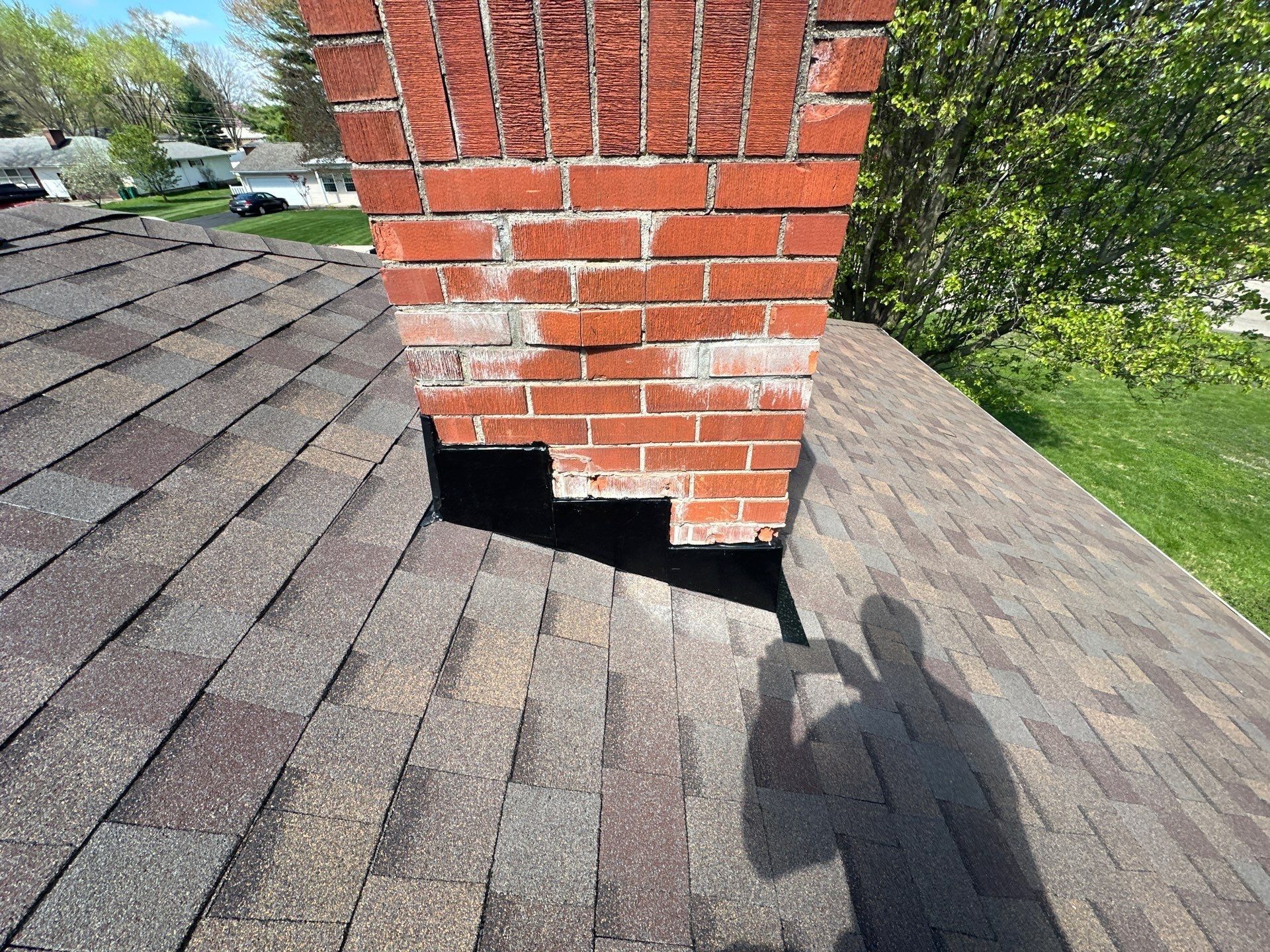 Stepped flashing up the side of the chimney above the new shingles, Beavercreek, Ohio.