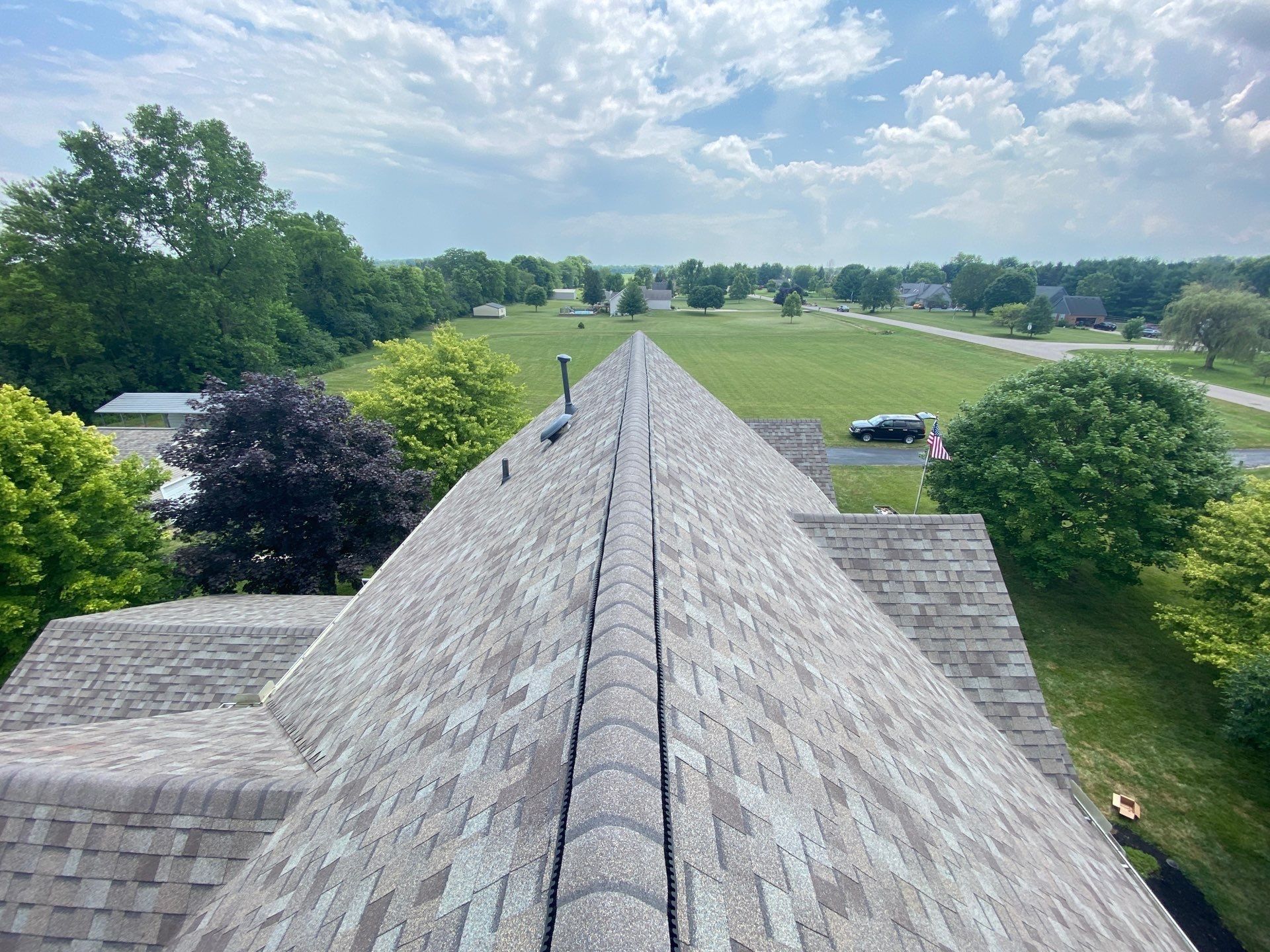 Ridge vent and cap shingles along the finished upper ridge, Yellow Springs, Ohio.