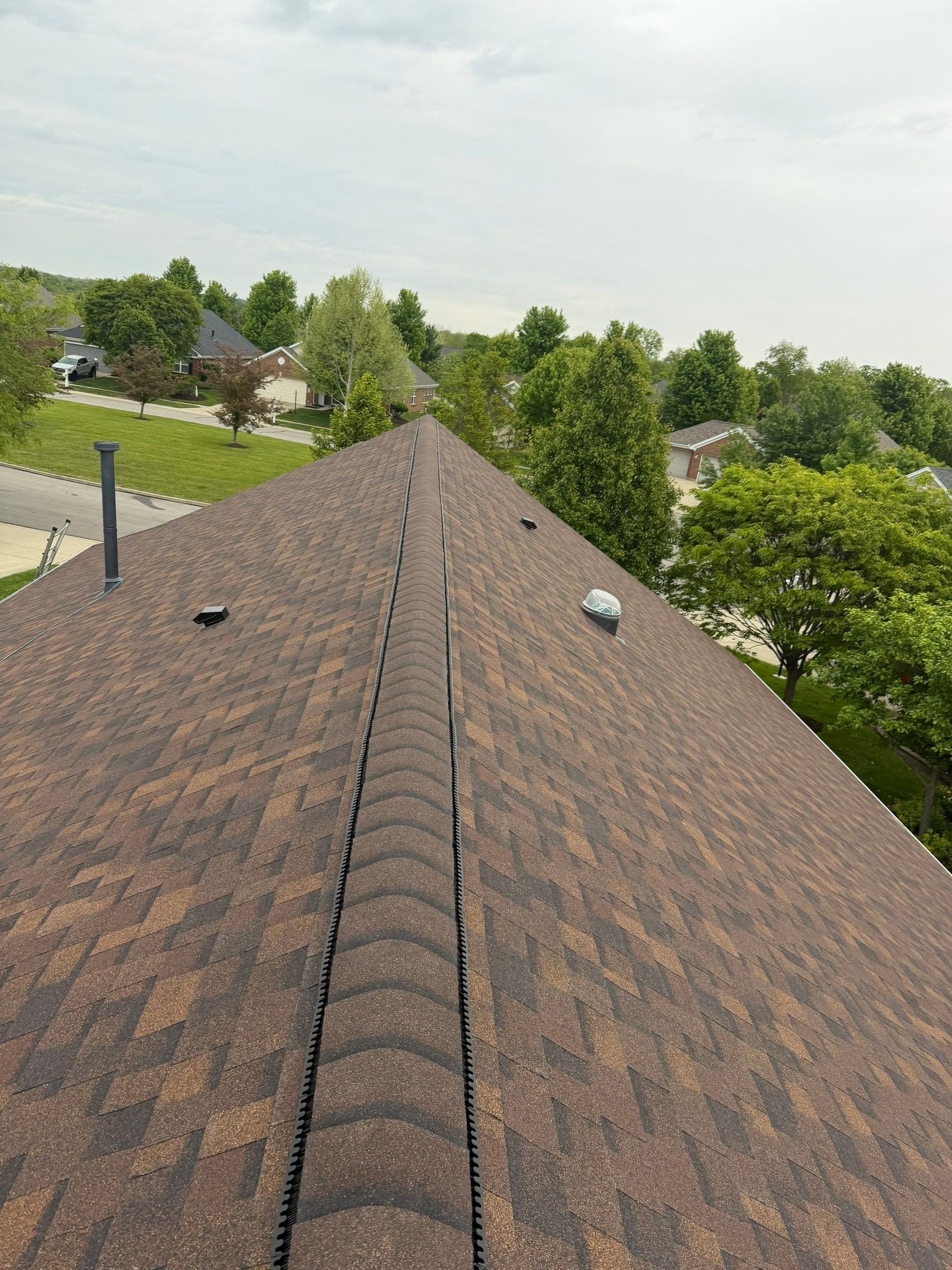 Ridge vent beneath the cap shingles