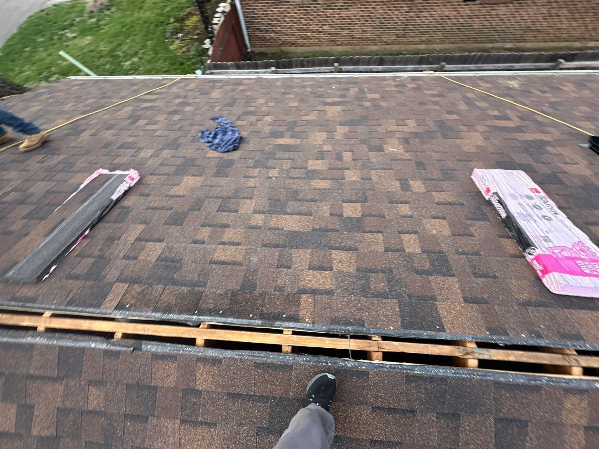 Shingles finished up to the ridge, with bundles of ridge cap laid out, Dayton, Ohio.
