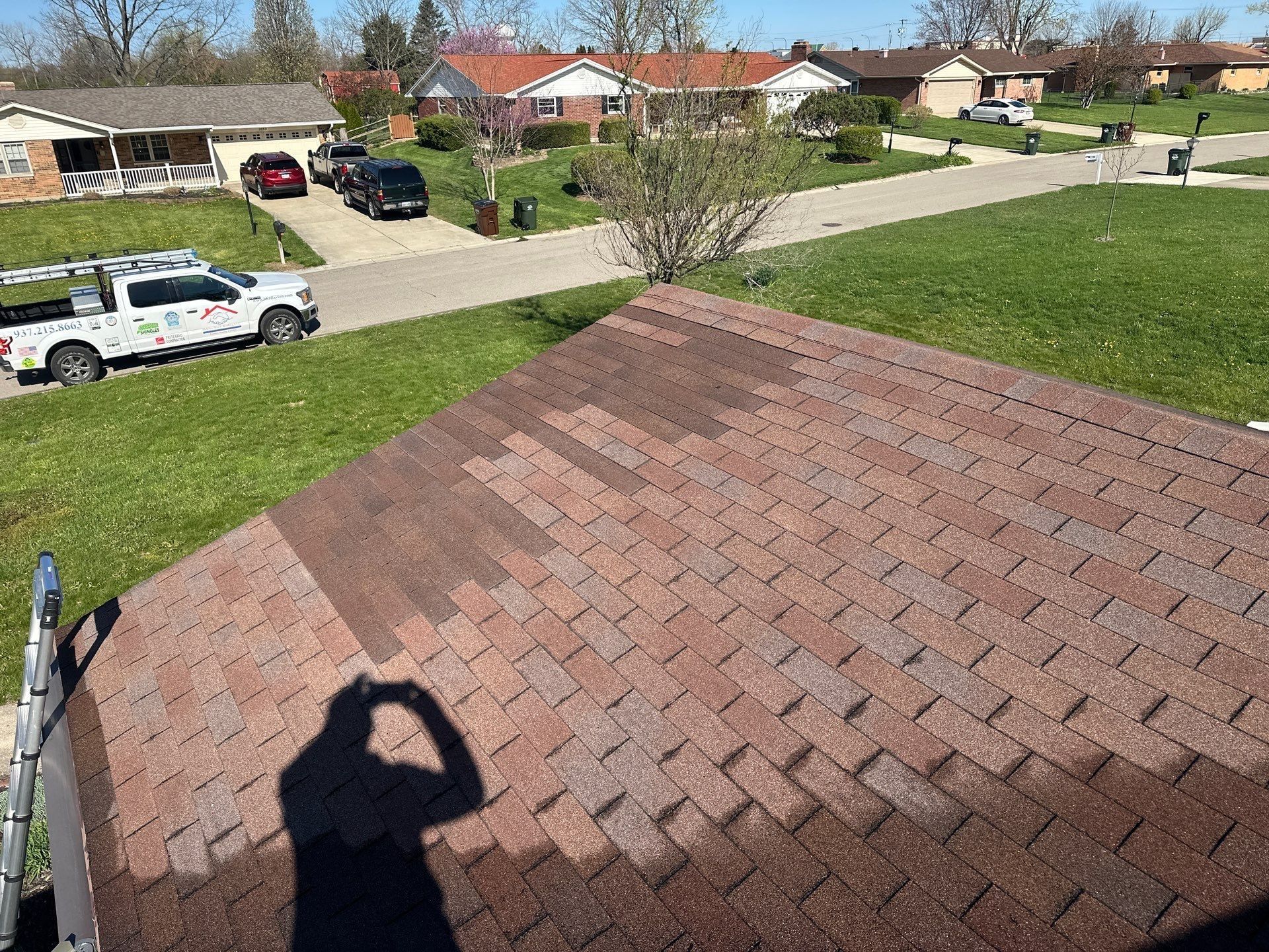 The old hip roof over the front, with the work truck at the curb, Beavercreek, Ohio.