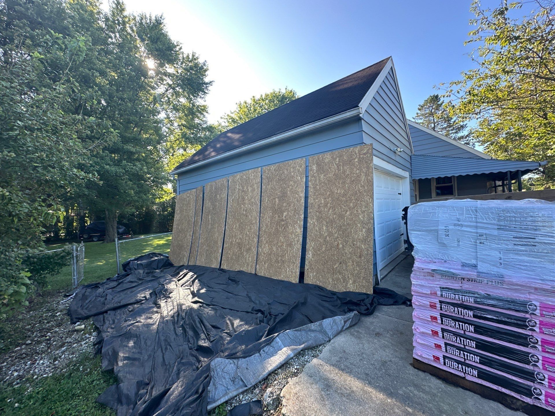 Plywood over the garage wall and a pallet of Duration shingles, Beavercreek, Ohio.