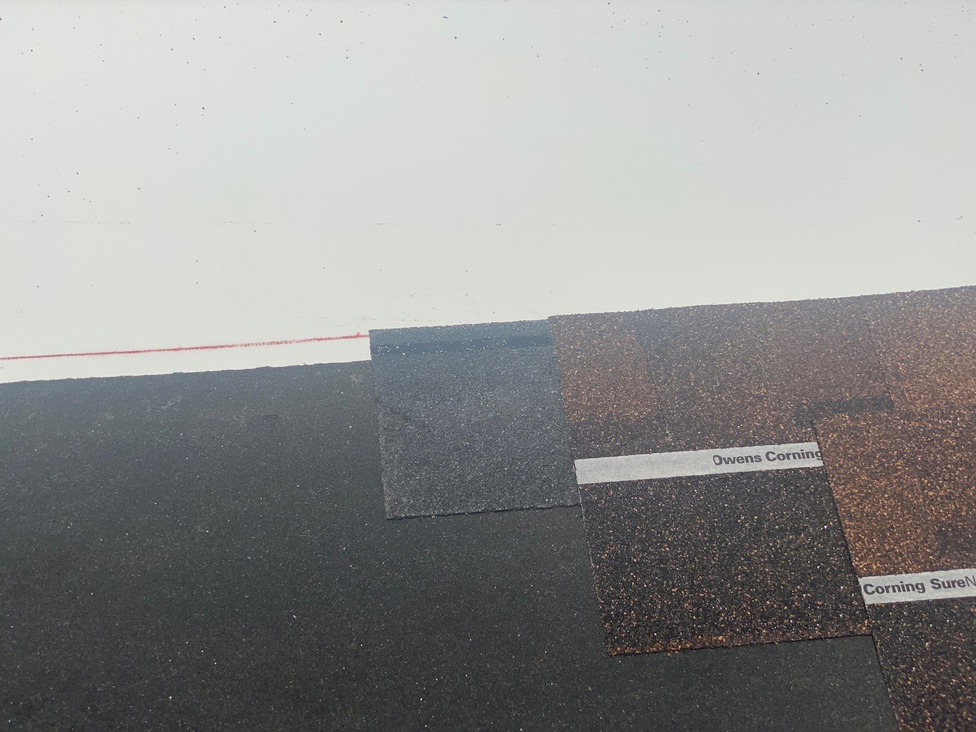 Starter strip and first Owens Corning shingle laid along the roof edge, Beavercreek, Ohio.