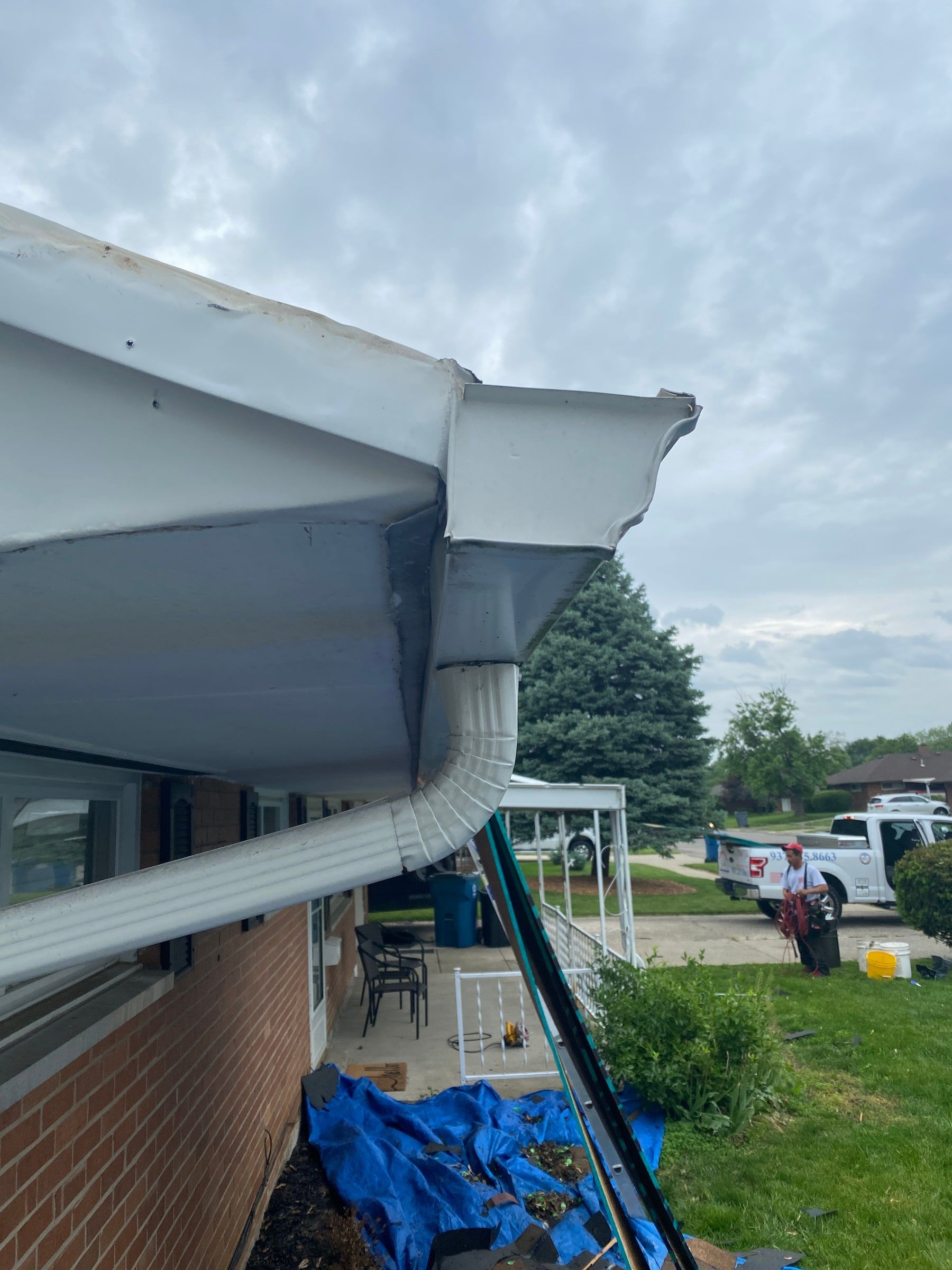 Tarps spread under the eave along the side of the house, Huber Heights, Ohio.