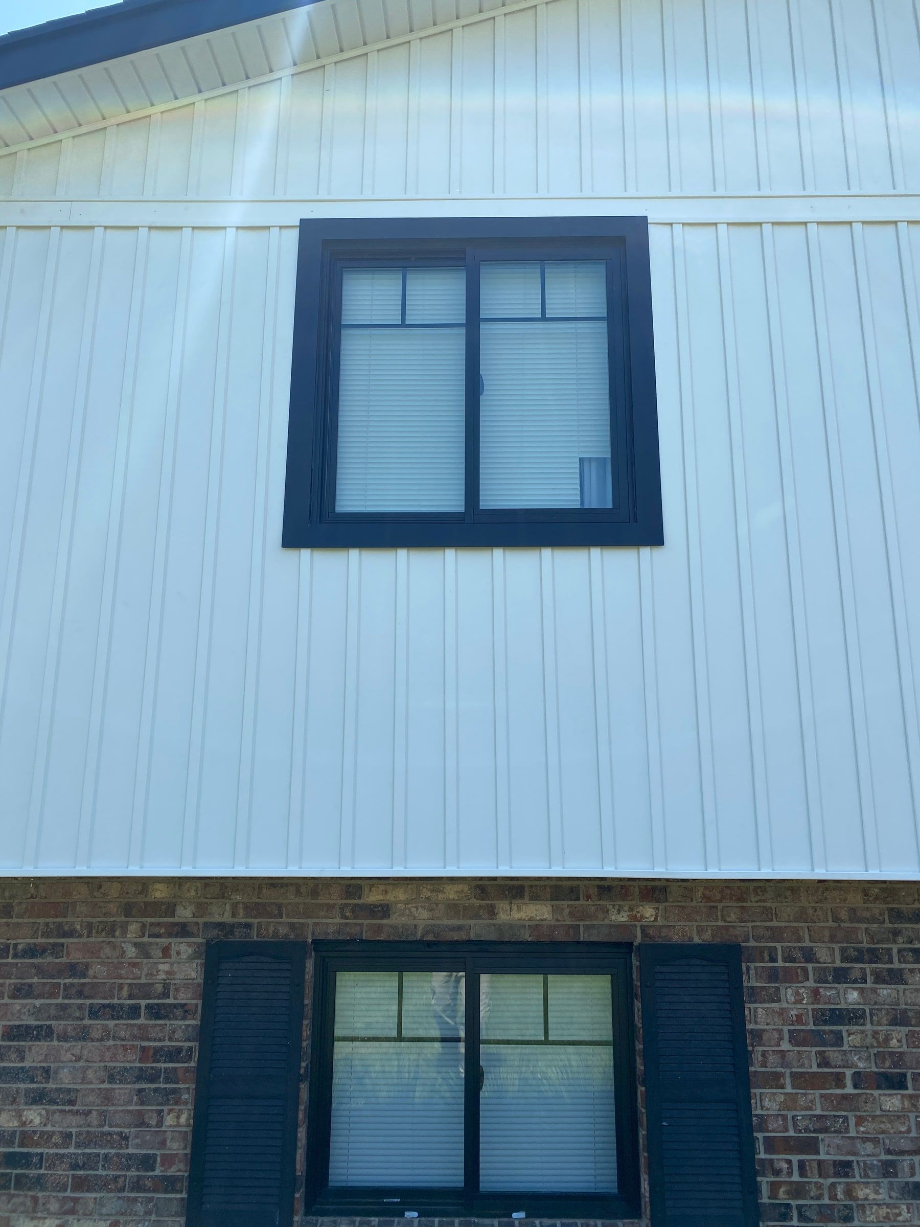 New dark trim around an upper window in the white board-and-batten siding, Beavercreek, Ohio.