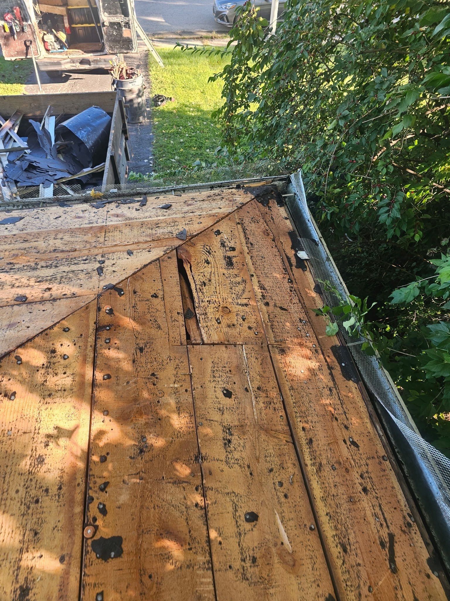 Split deck boards at the eave above the old gutter screen, Kettering, Ohio.
