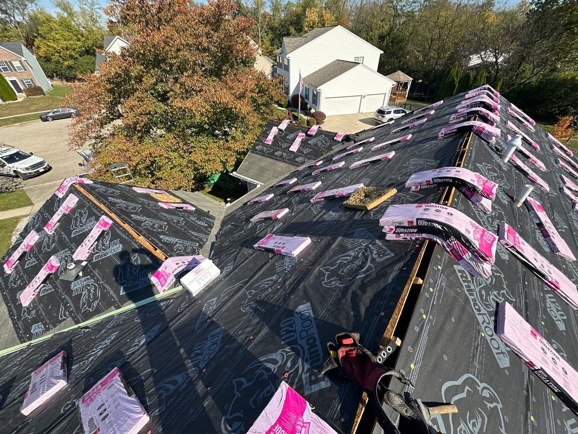 Shingle bundles laid over the ridges, the neighborhood street beyond, Beavercreek, Ohio.