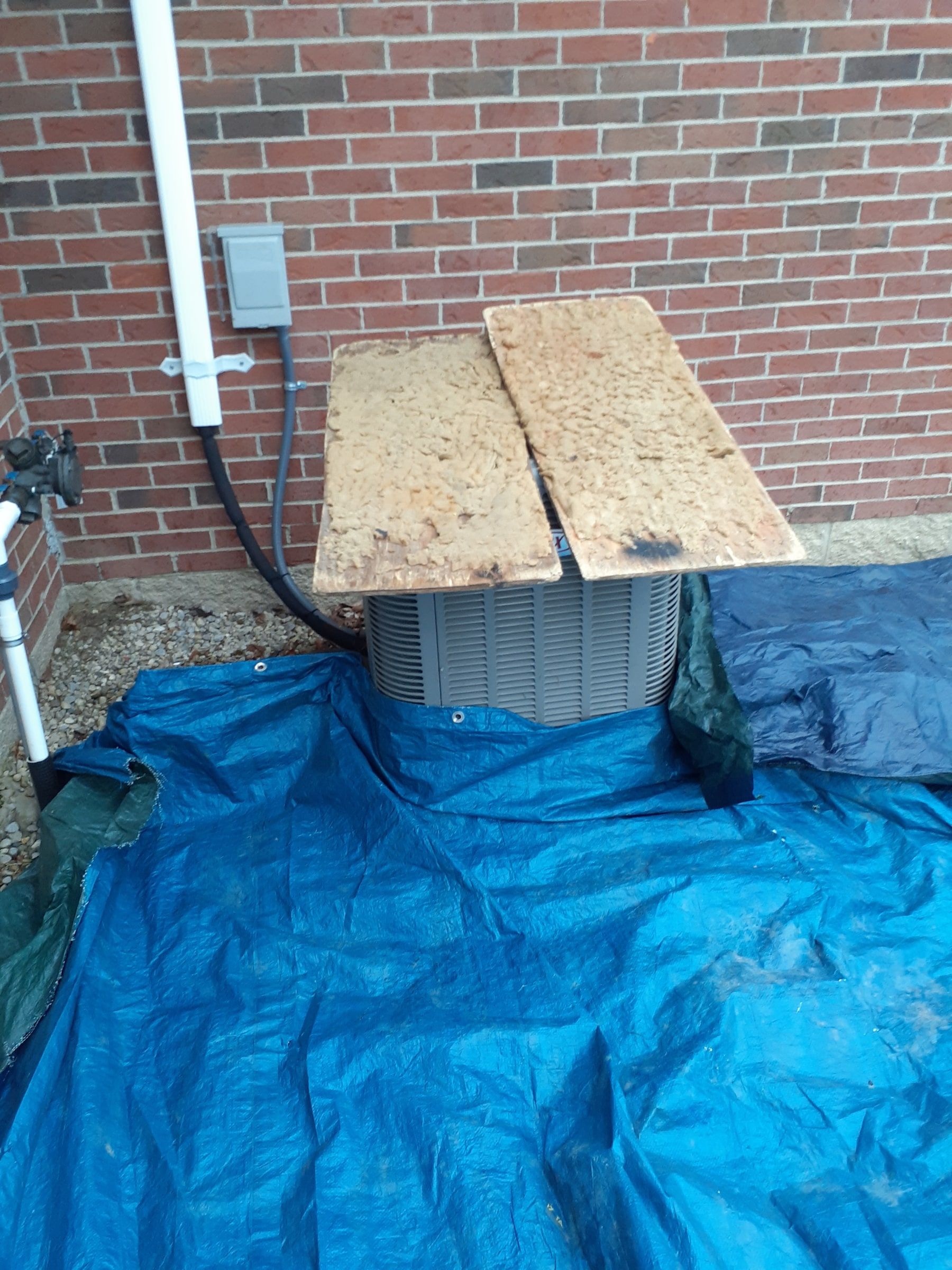 Condenser boarded over and tarped