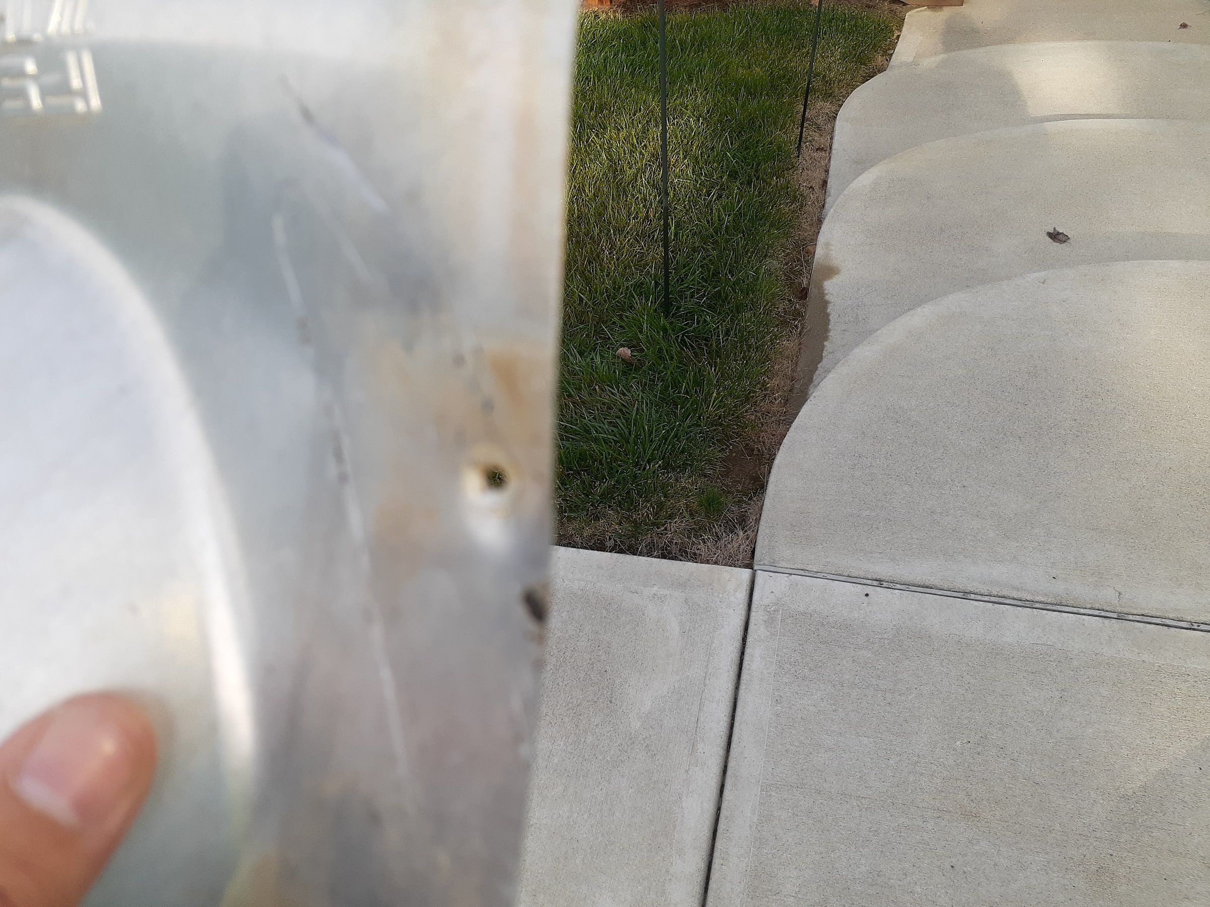 Metal section against the driveway
