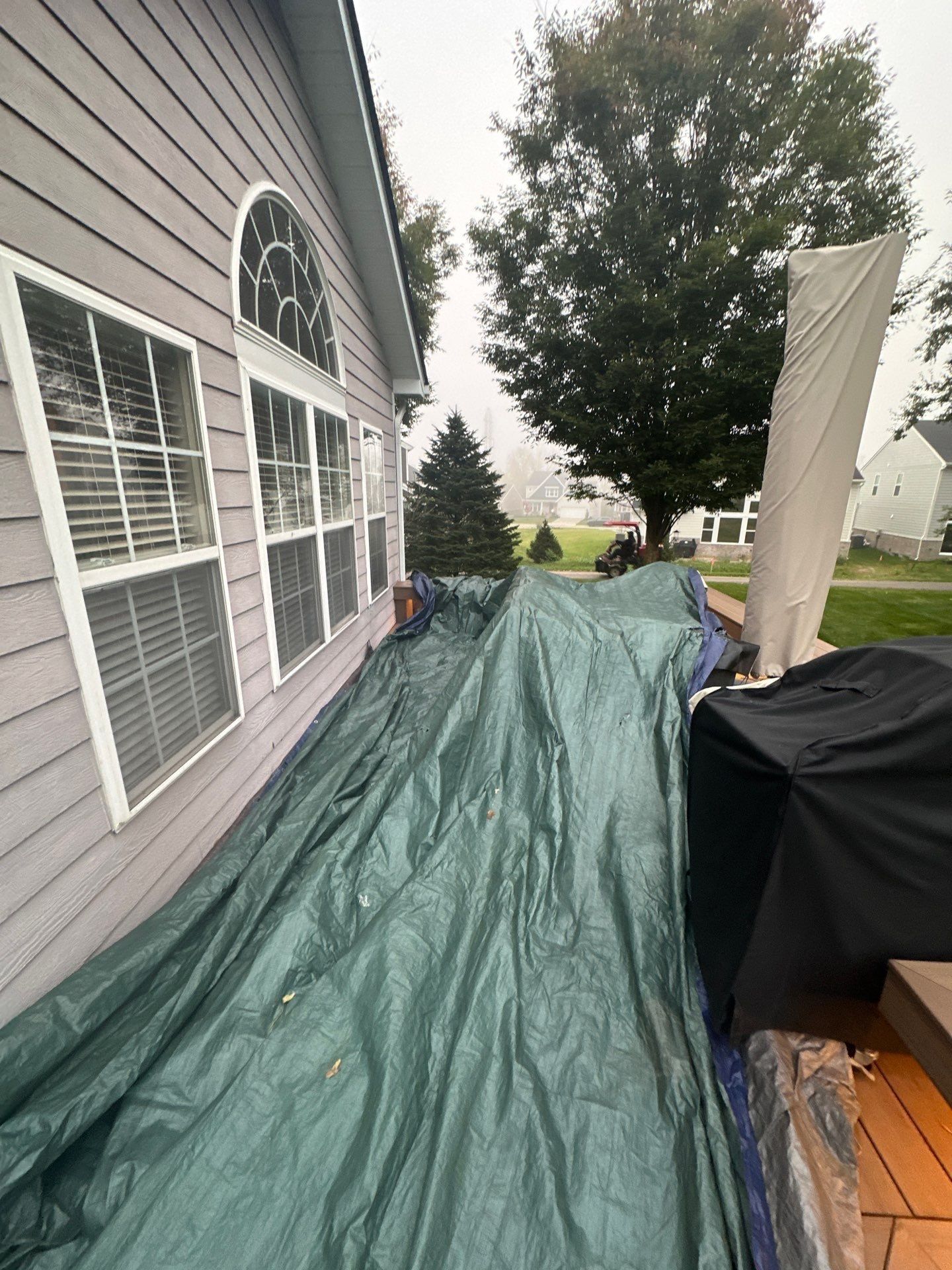 A long tarp laid along the back wall over the deck, Beavercreek, Ohio.