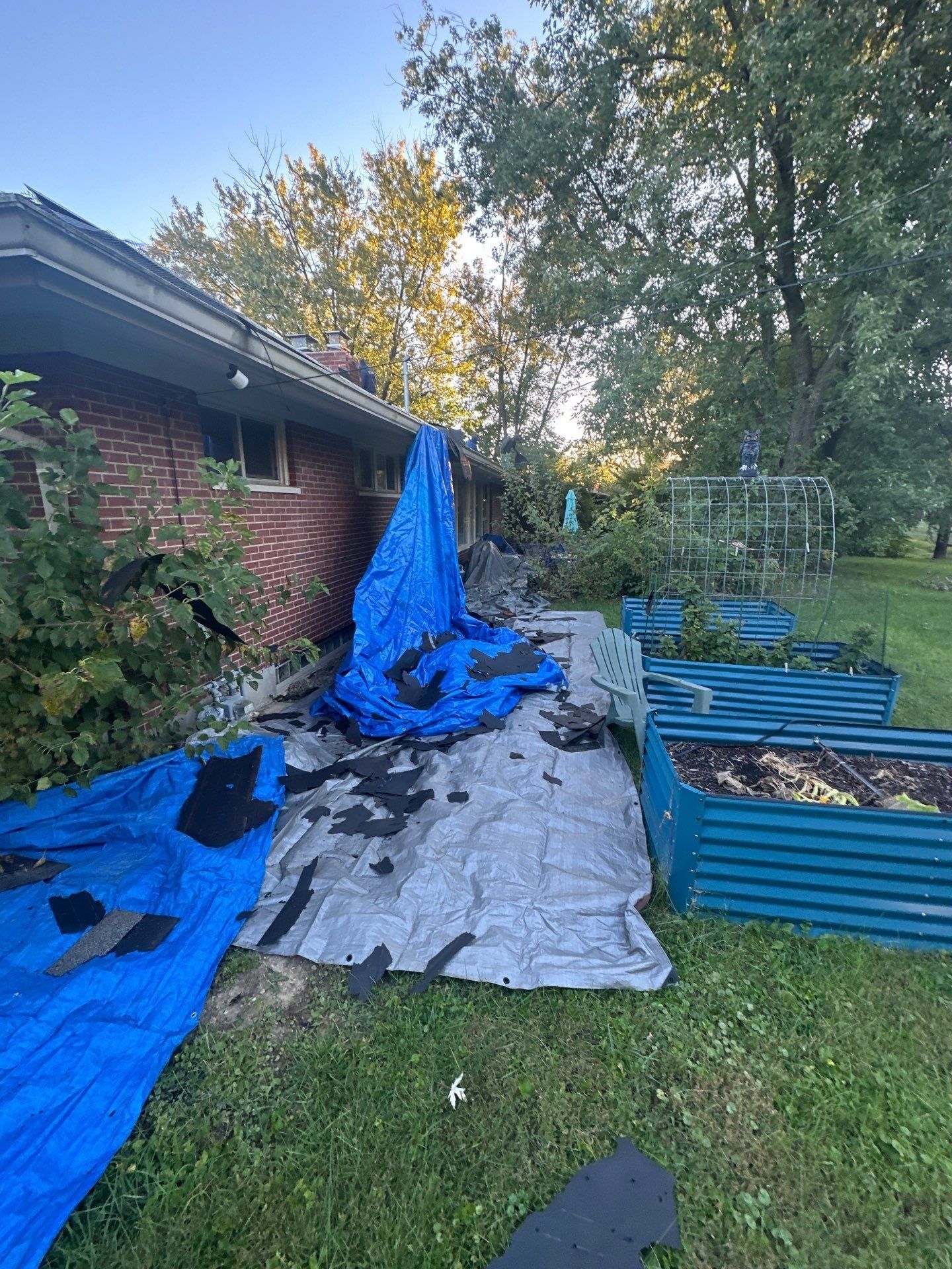 A tarp draped over the garden beds beside the house, Kettering, Ohio.