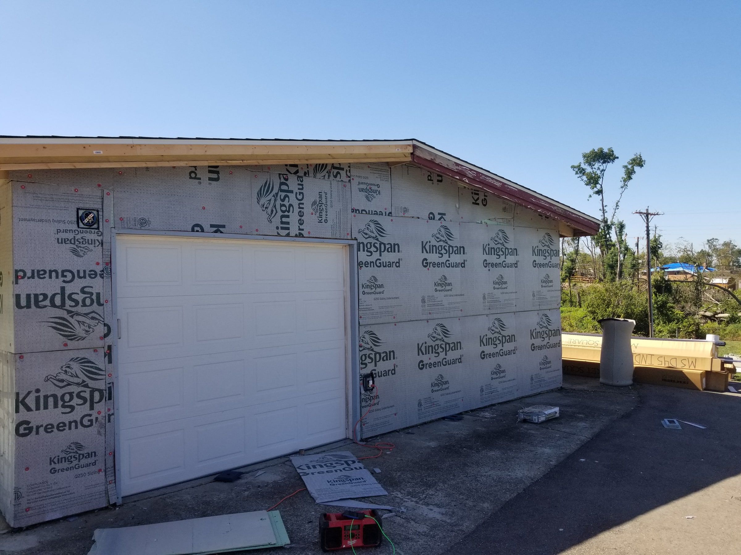 Fanfold insulation board on the garage wall around the white door, Beavercreek, Ohio.