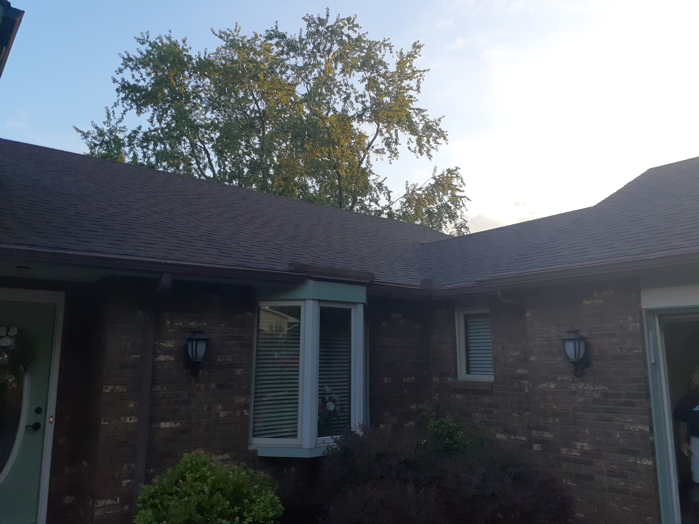 Front entry and bay window below the old shingle roof, Jamestown, Ohio.